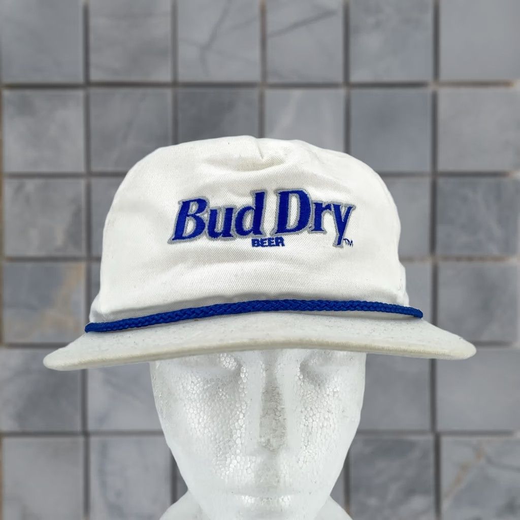 Budweiser VINTAGE Bud Dry Beer Hat Cap Strap Back White Blue Rope Budweiser Beer Promo 90s Mens Adjustable Cap White Beer 90s Budweiser Mens Hat Size ONE SIZE - 1 Thumbnail