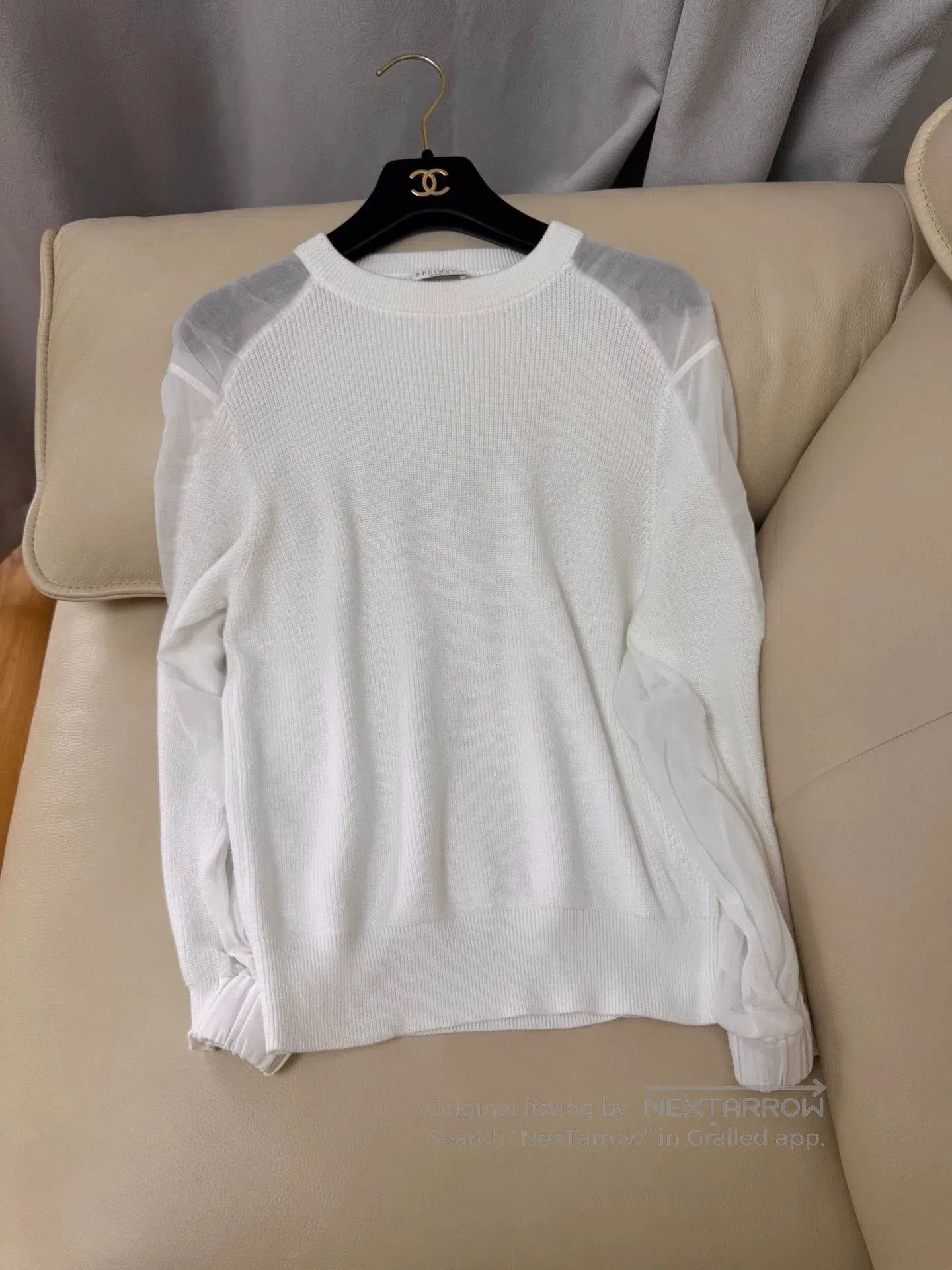 white knit top with mesh sleeves.