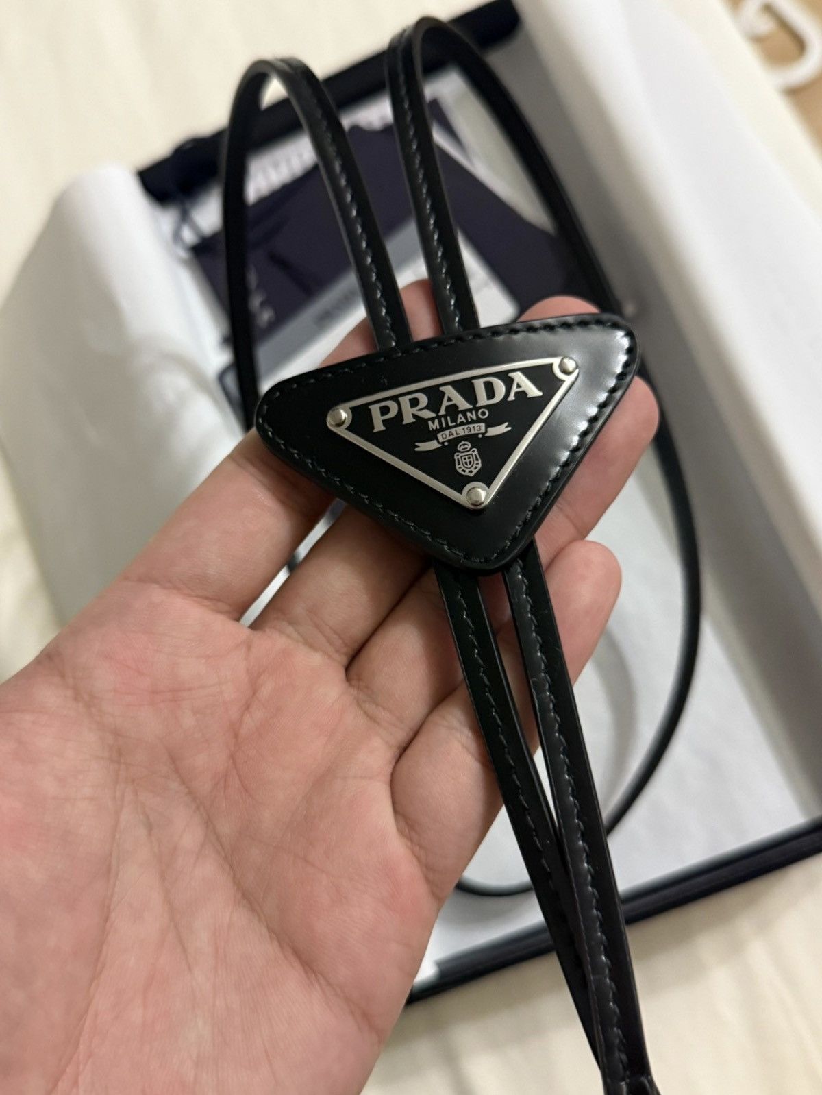 Prada Prada Logo Embellished Glossy Leather Bolo Tie Size ONE SIZE - 1 Thumbnail