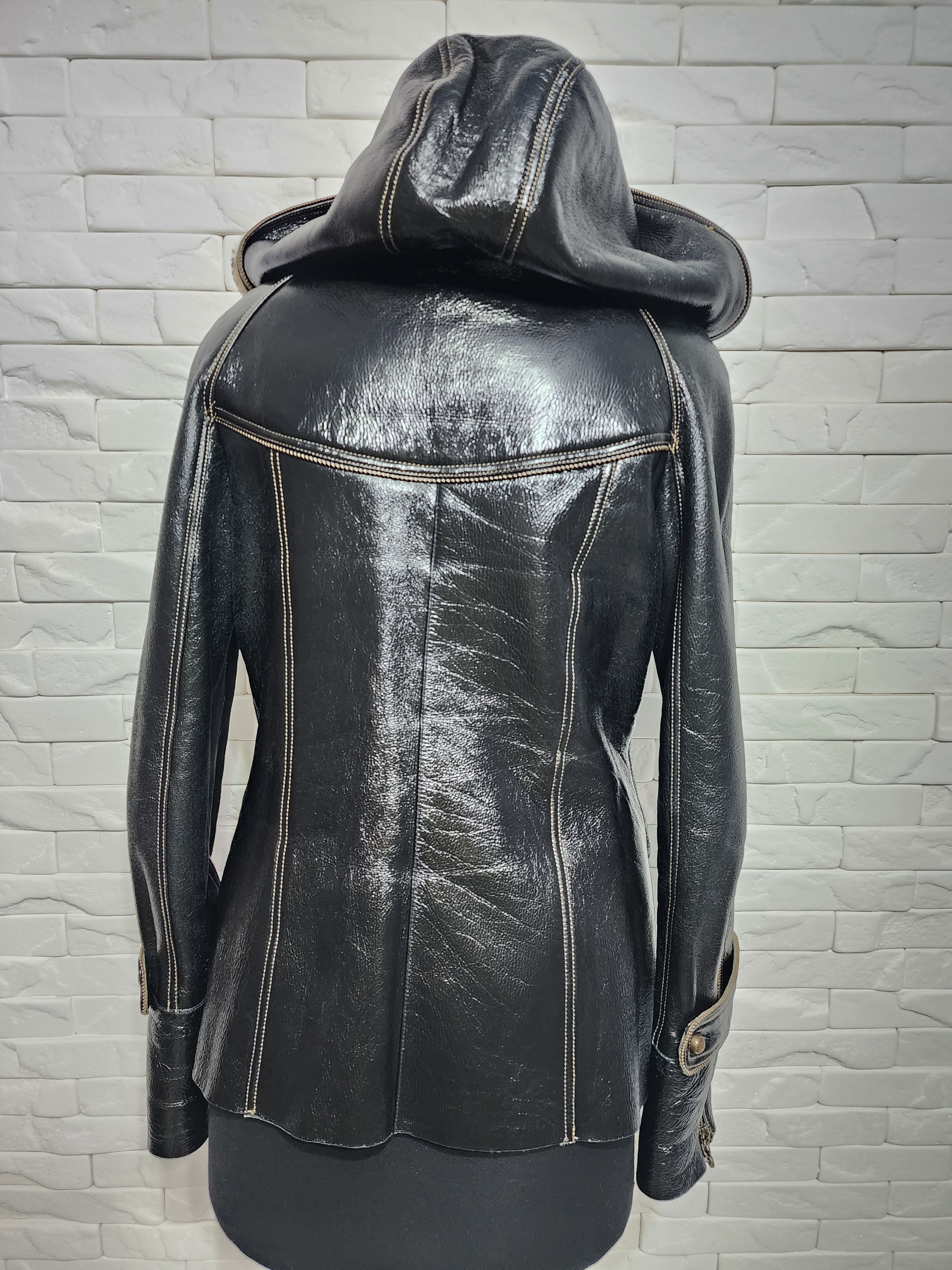 Black sheepskin coat with a metal zipper and hood.