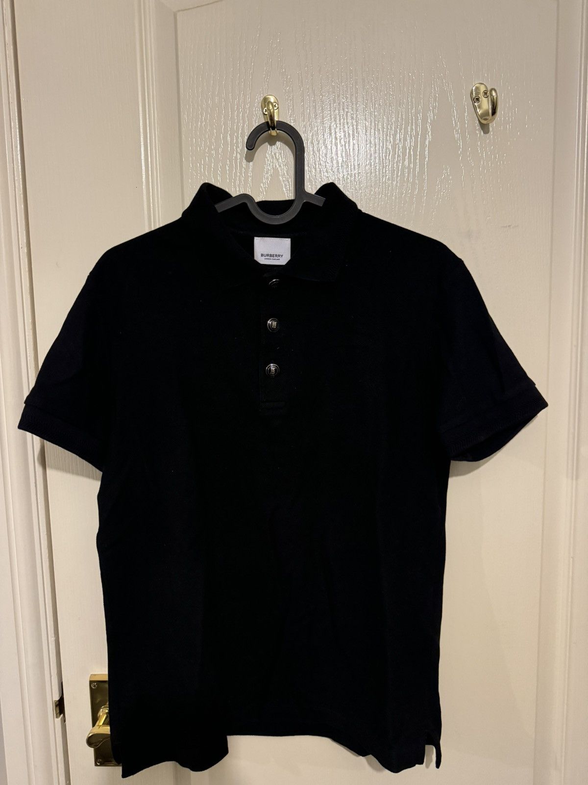 Image of Burberry Embossed Buttons Polo Shirt in Black, Men's (Size XS)