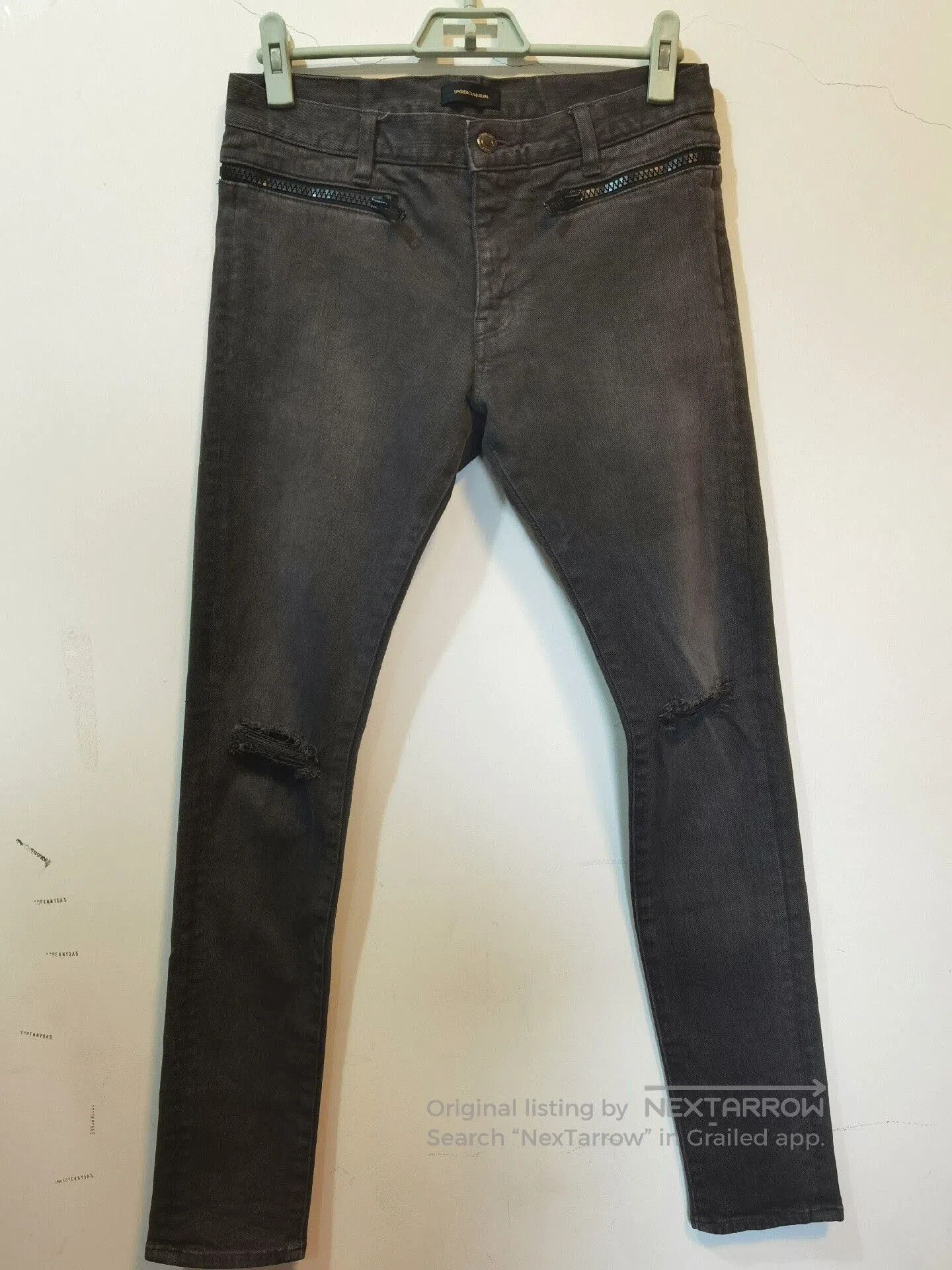 distressed skinny jeans with zipper details.