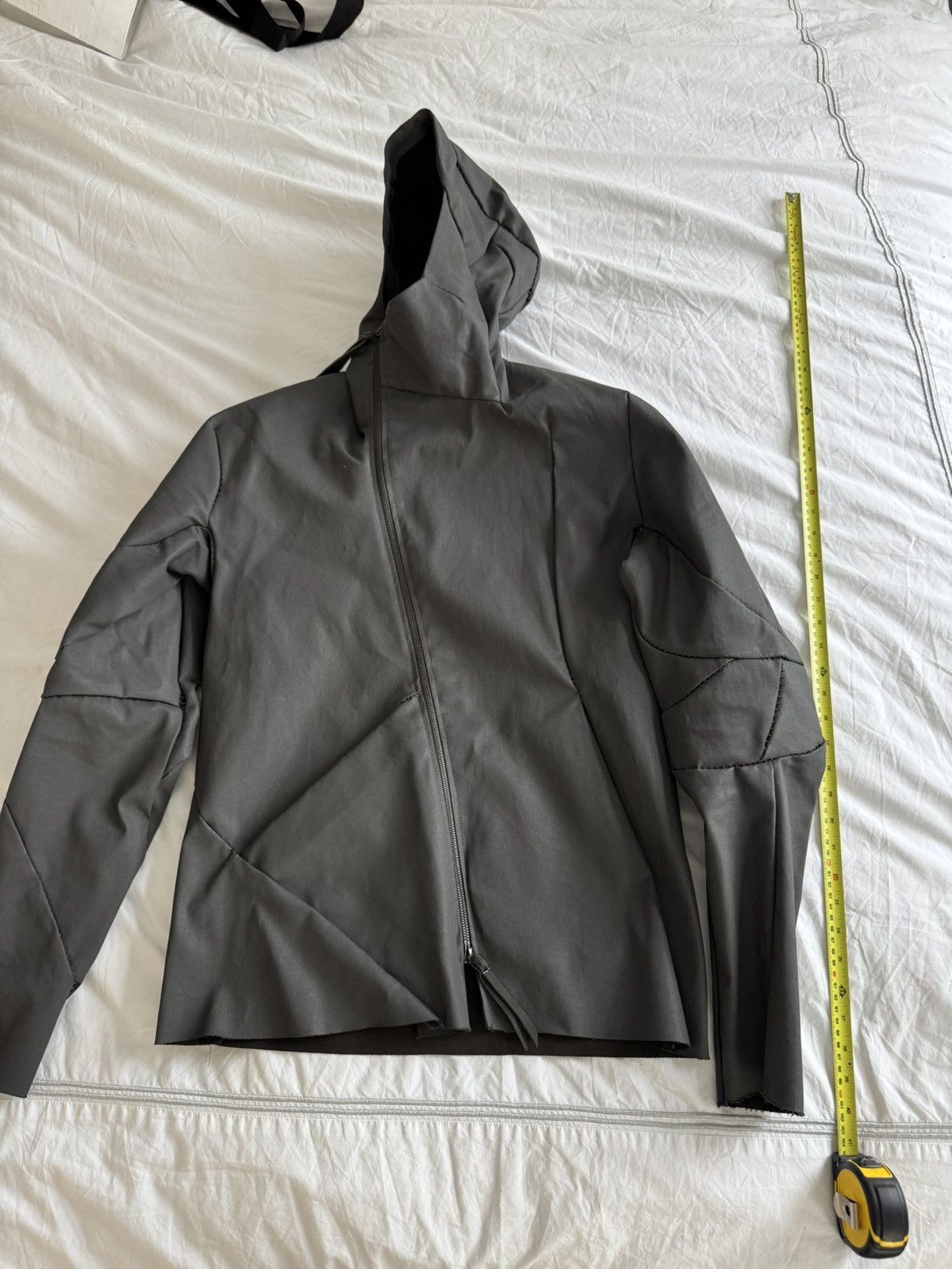 Unlined hand stitched hooded jacket.