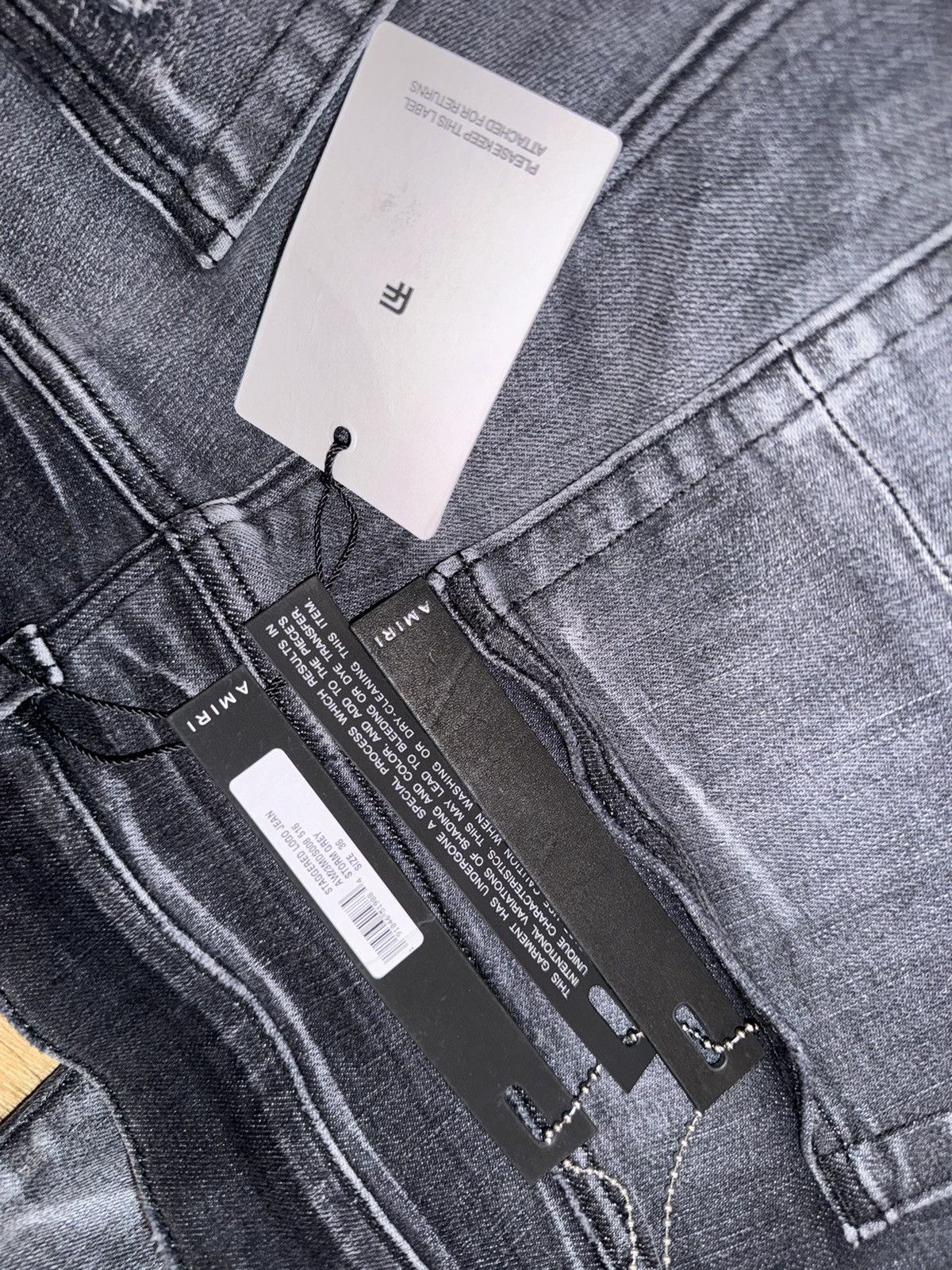 AMIRI logo-print ripped skinny jeans