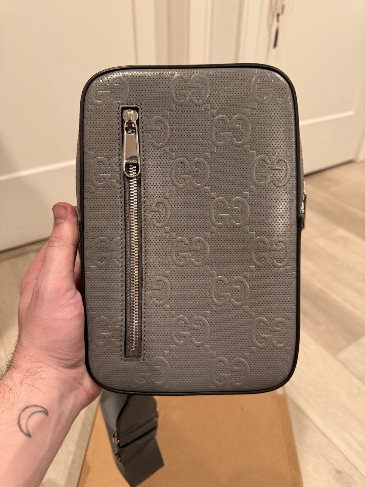 image of Gucci Men's Gray GG Embossed Sling Bag in Grey