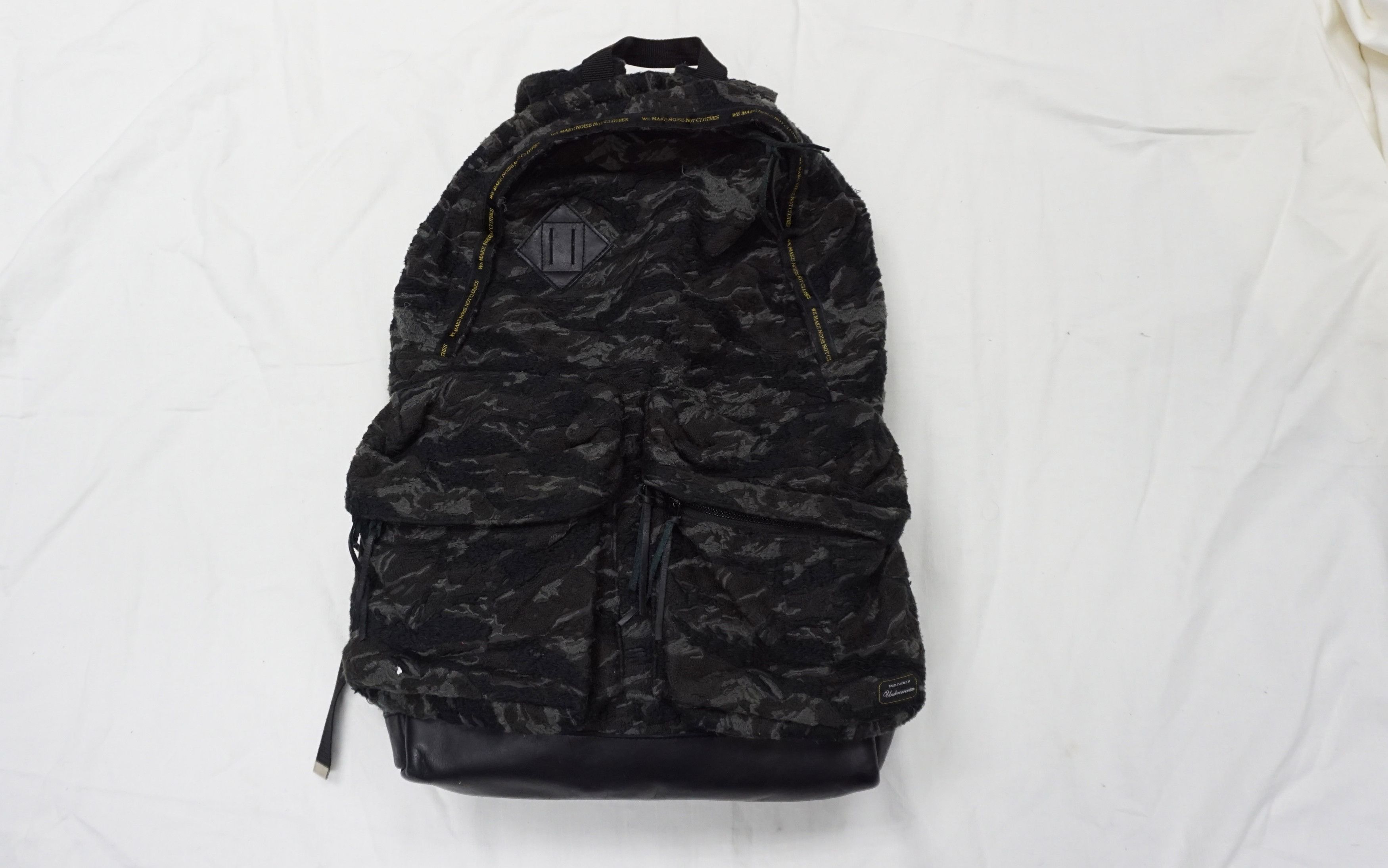 image of Art x Undercover Embroidered Camo Backpack in Black, Men's
