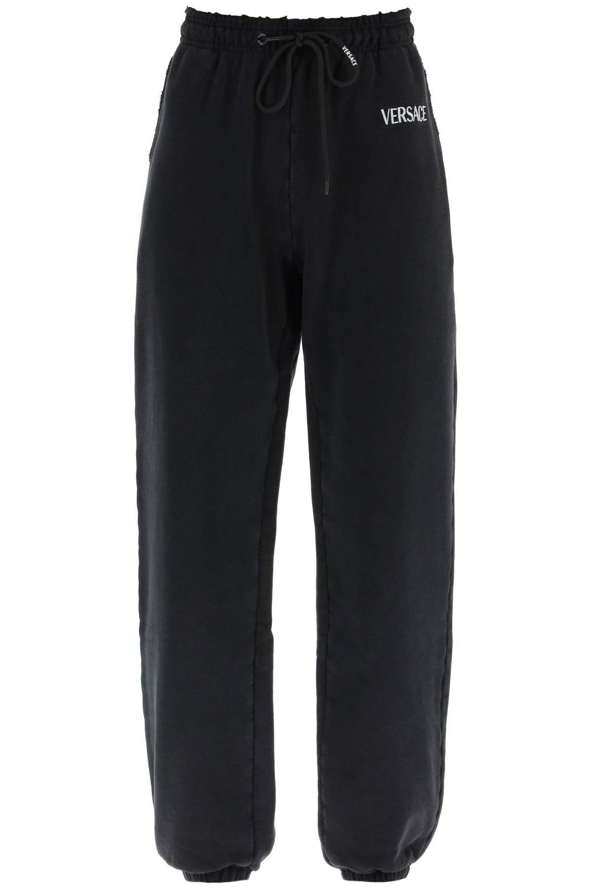 image of Versace Distressed Jogger Pants With Logo Embroidery in Black White, Women's (Size 26)
