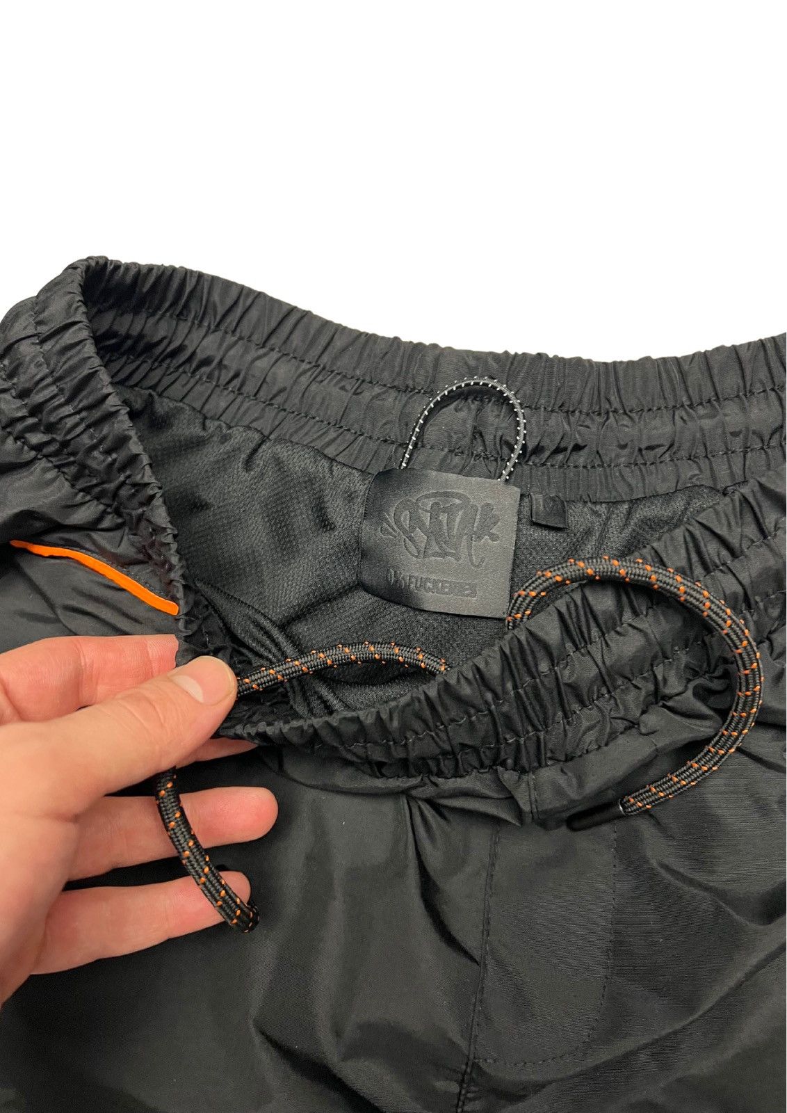 Syna World Shell Tracksuit “BLACK/ORANGE” - Tops Syna World Shell Tracksuit “BLACK/ORANGE” - Tops