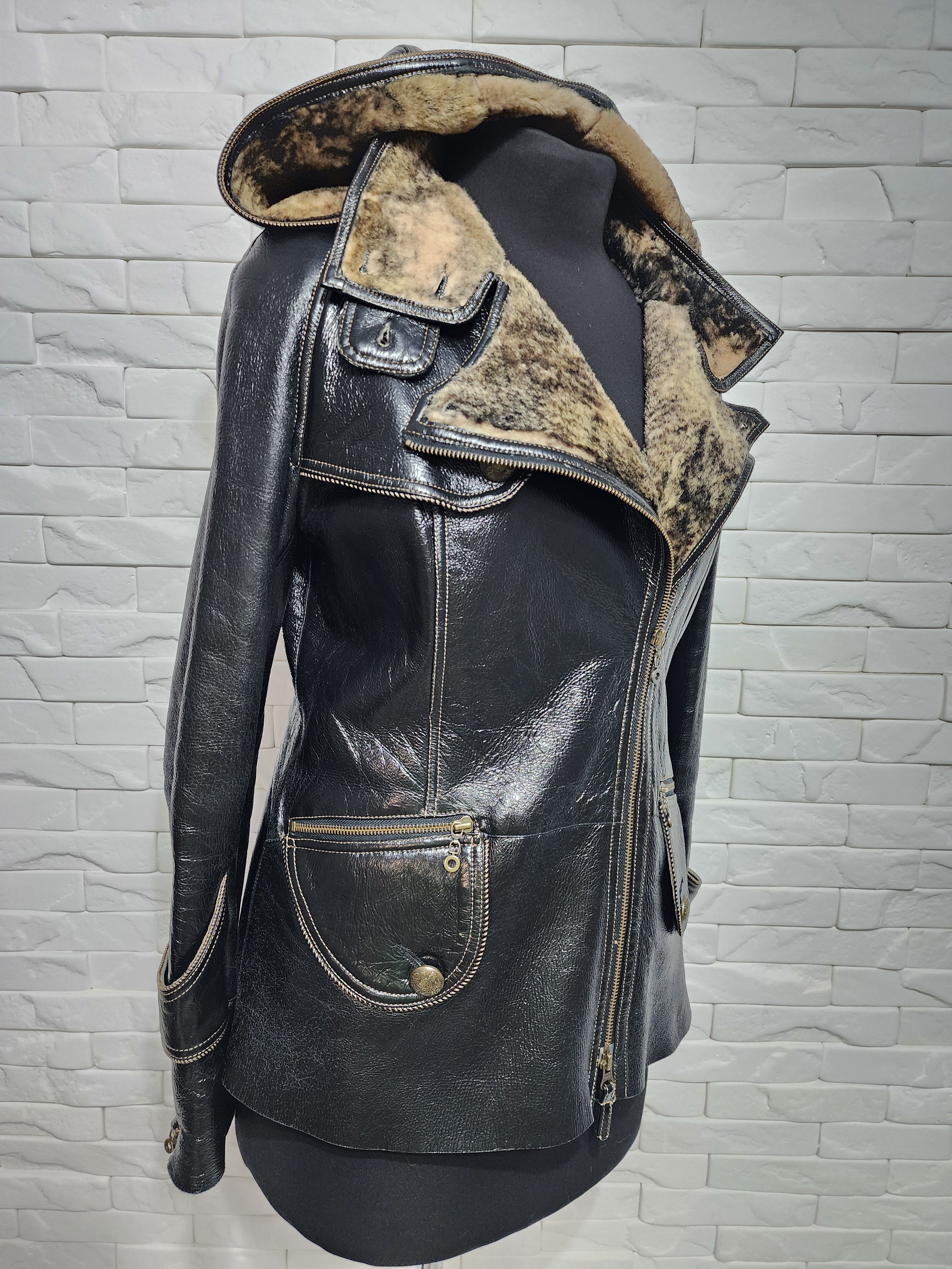 Black sheepskin coat with a metal zipper and hood.