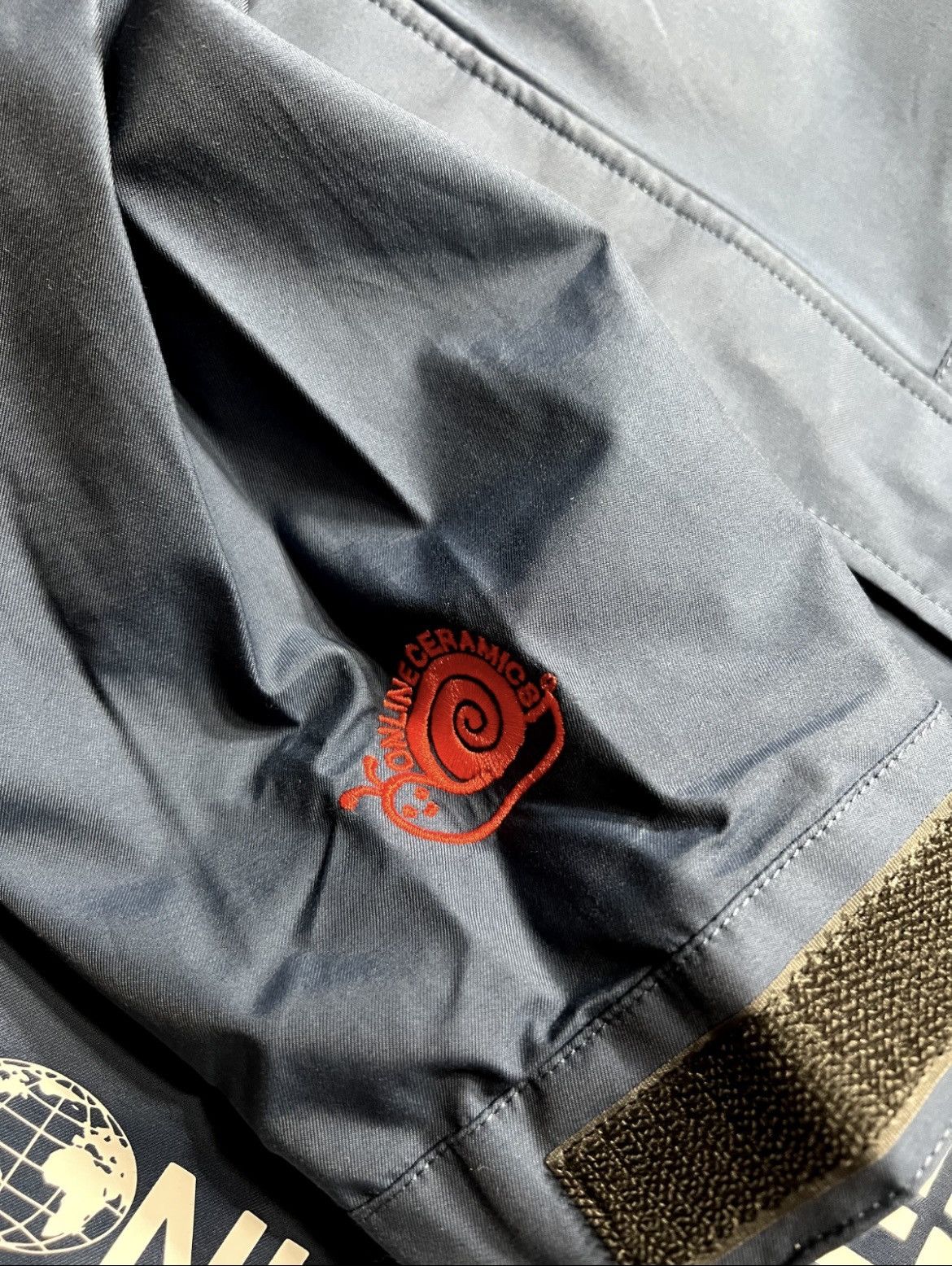 Online Ceramics × The North Face THE NORTH FACE X ONLINE CERAMICS MENS WIND JAMMER JACKET Size US S / EU 44-46 / 1 - 5 Thumbnail