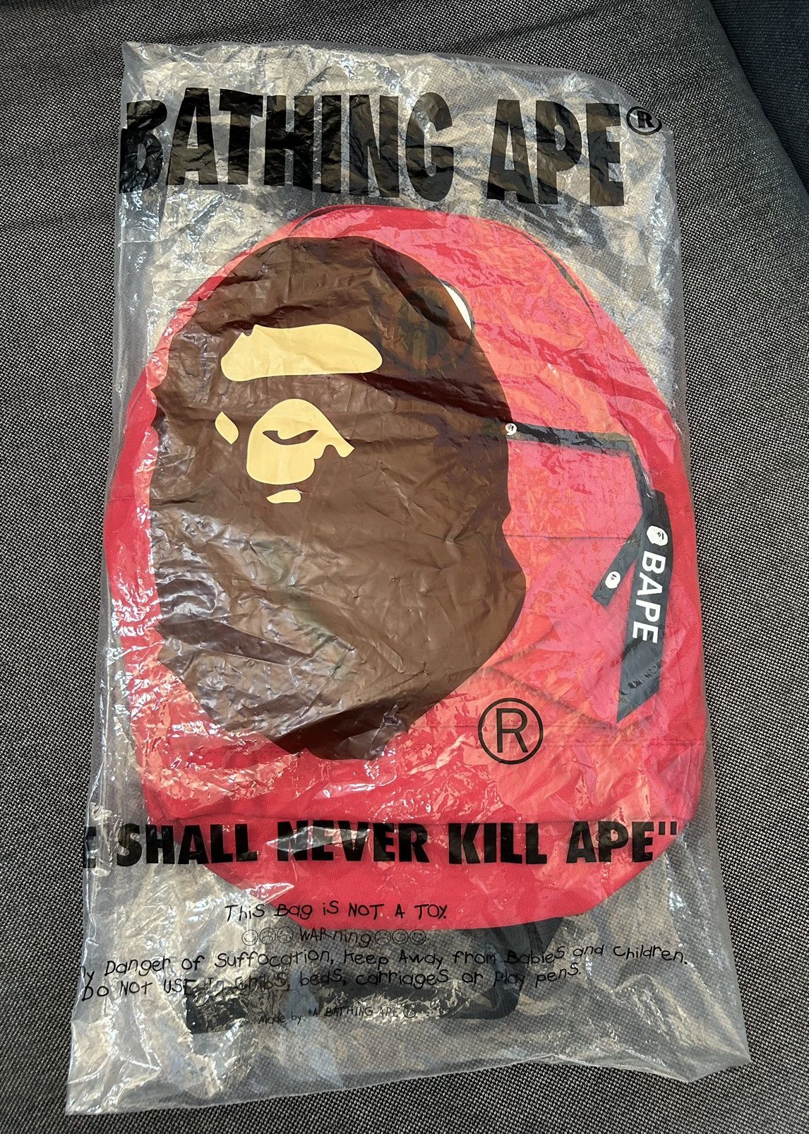 image of Bape Happy New Year Ape Head Patch Backpack in Red, Men's