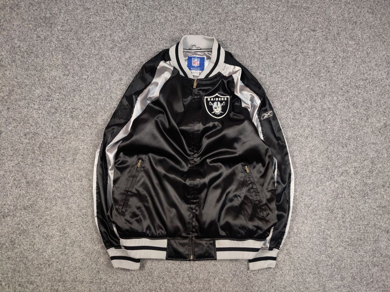 Vintage Vintage 90's NFL Raiders x Reebok Black Logo Bomber Jacket