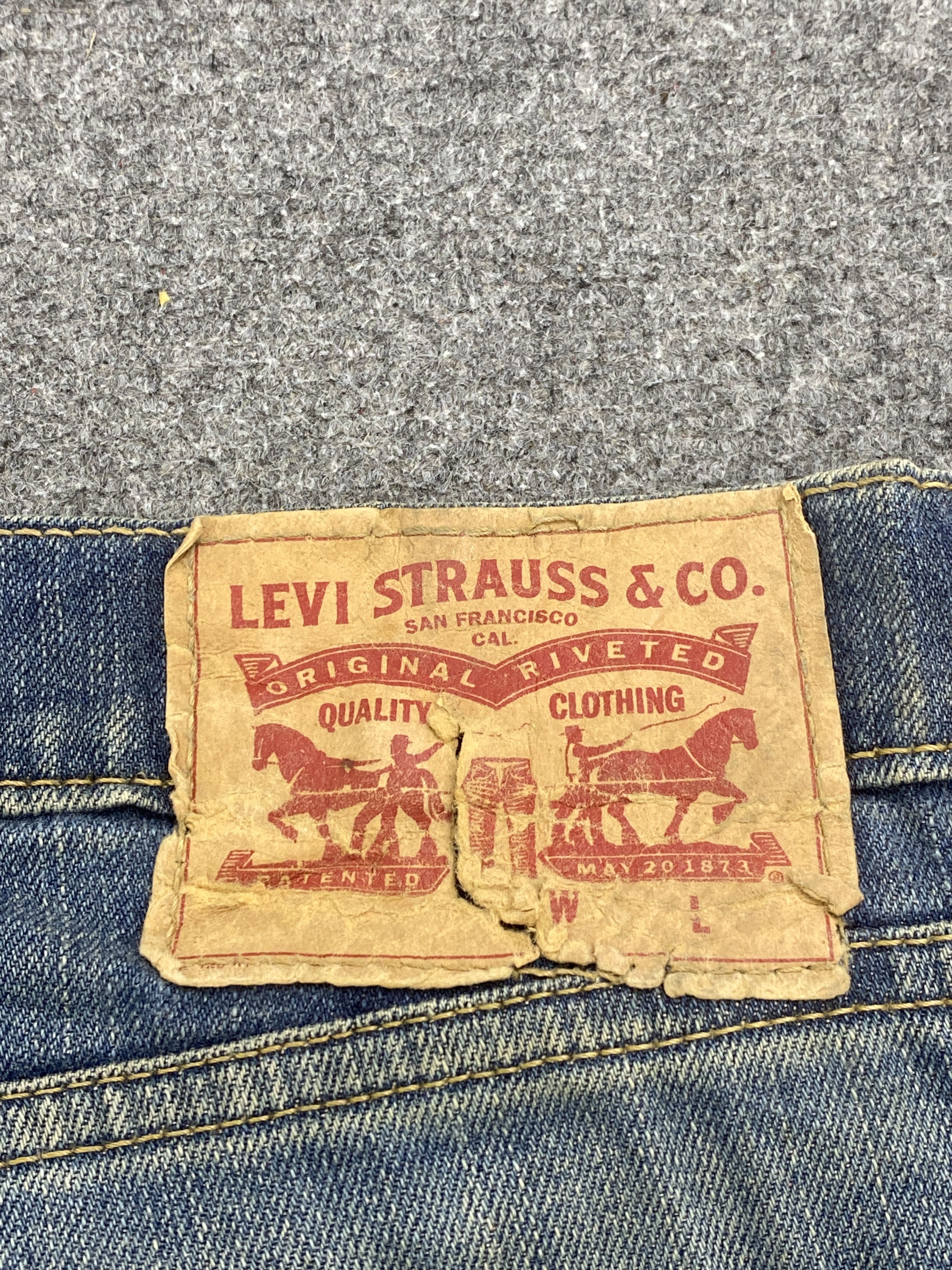Distressed Vintage Levi's 514 Faded Blue Jeans
