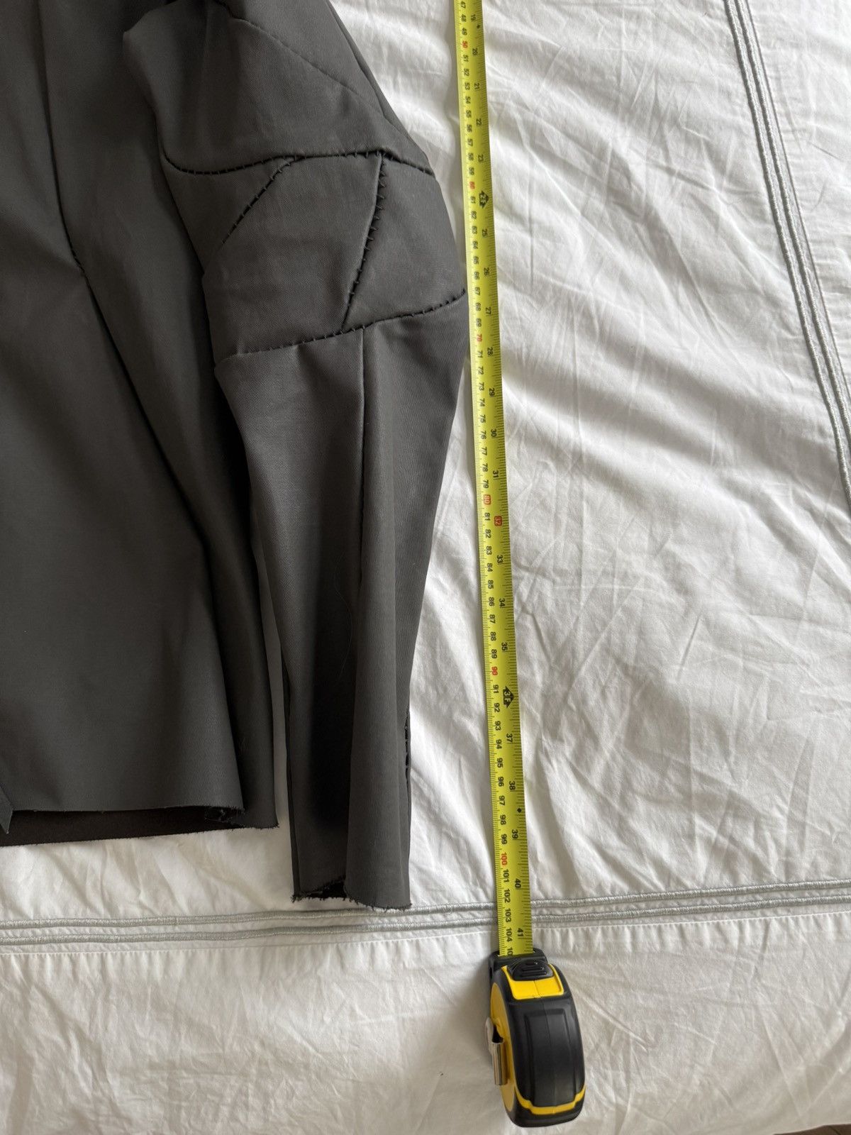 Unlined hand stitched hooded jacket.