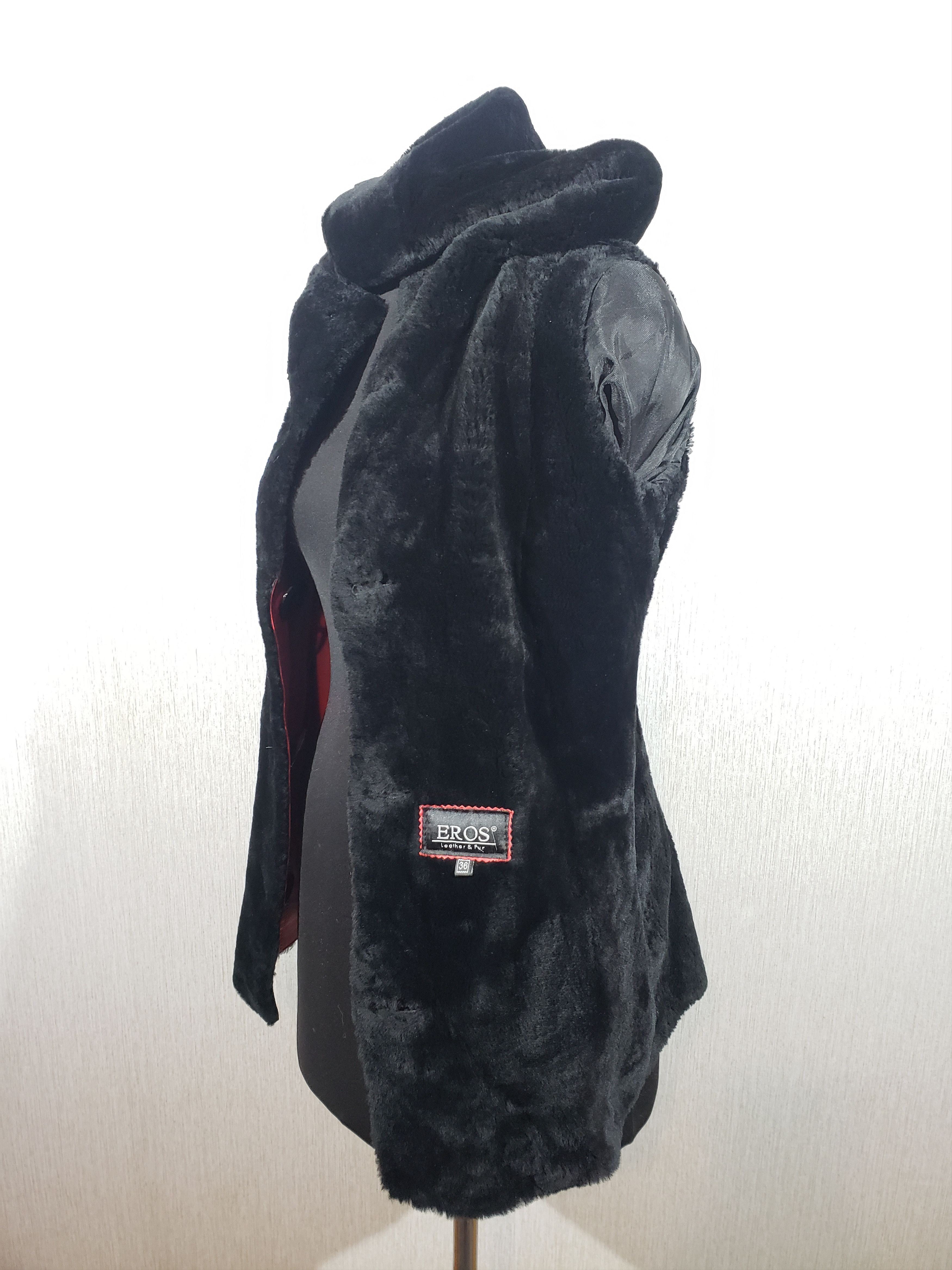 Stylish women's red sheepskin coat with a hood. Fur Faux Fur