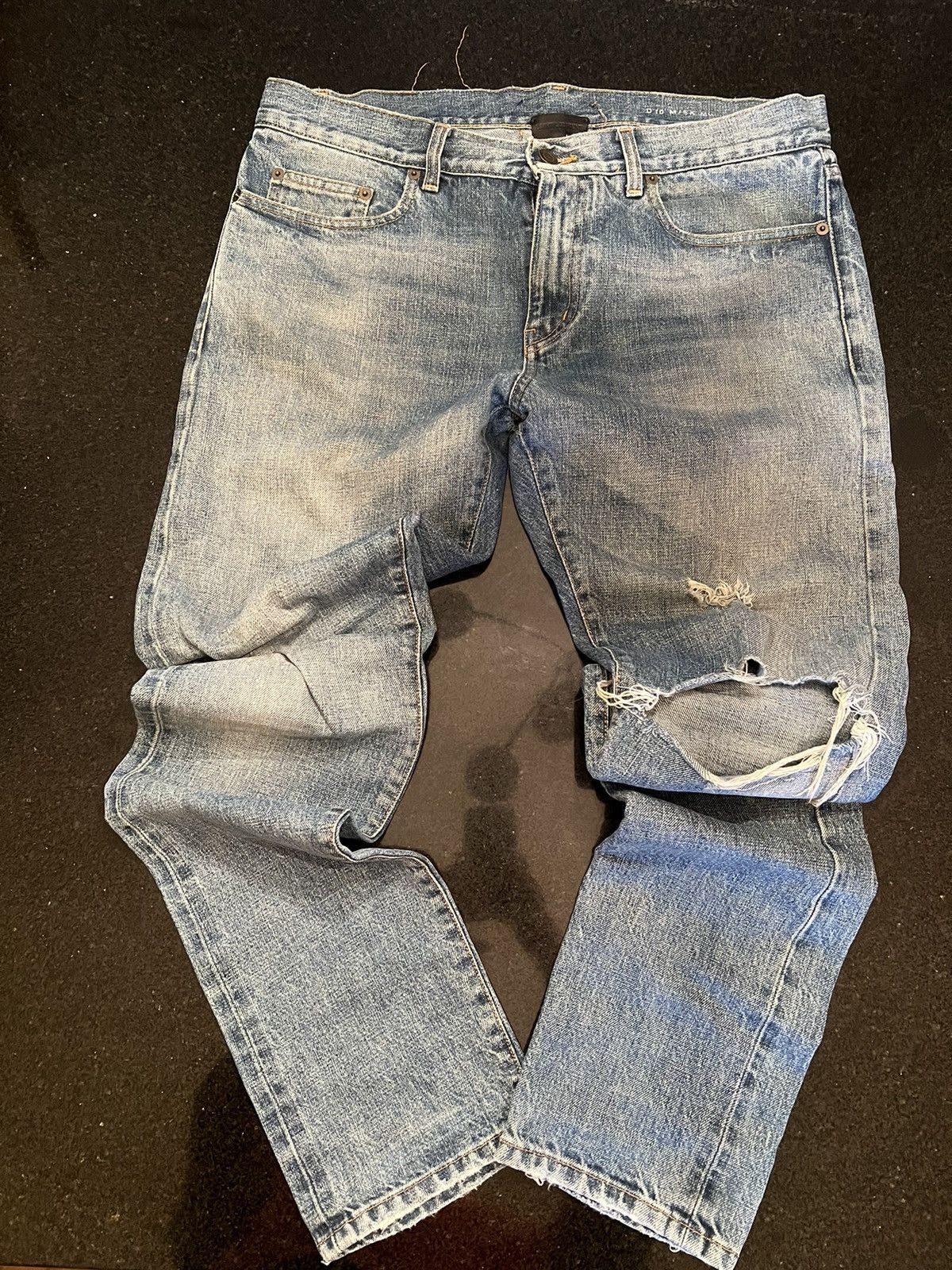 image of Saint Laurent Paris Ripped Knee Distressed Denim in Blue, Men's (Size 32)