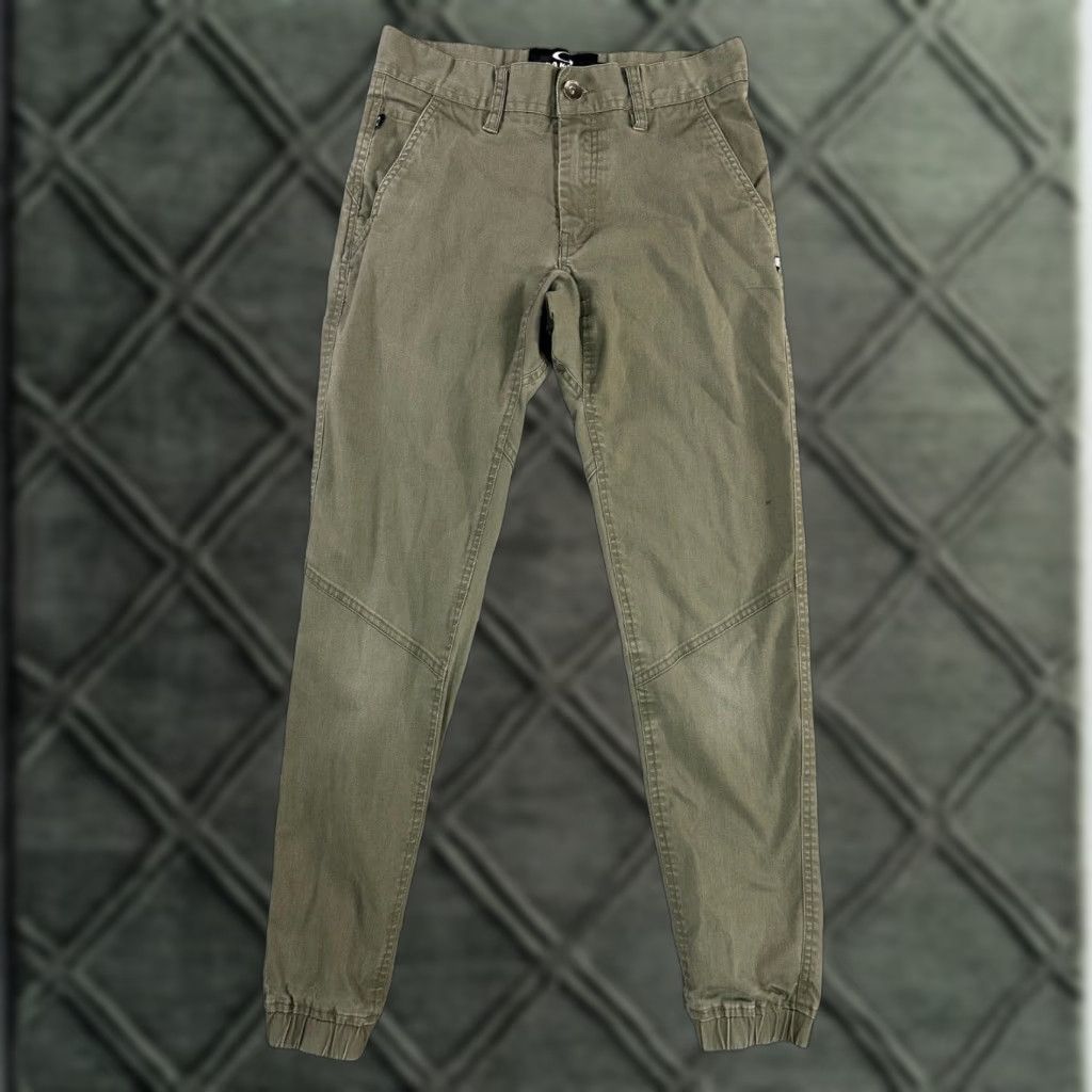 Oakley Oakley Pants Mens Olive Green Stretch Tapered Elastic Cuffs Size 28 Front Flat Front Zipper Logo Belt Loops 60/36/4 Elastane Casual Pants Size US 28 / EU 44 - 1 Thumbnail