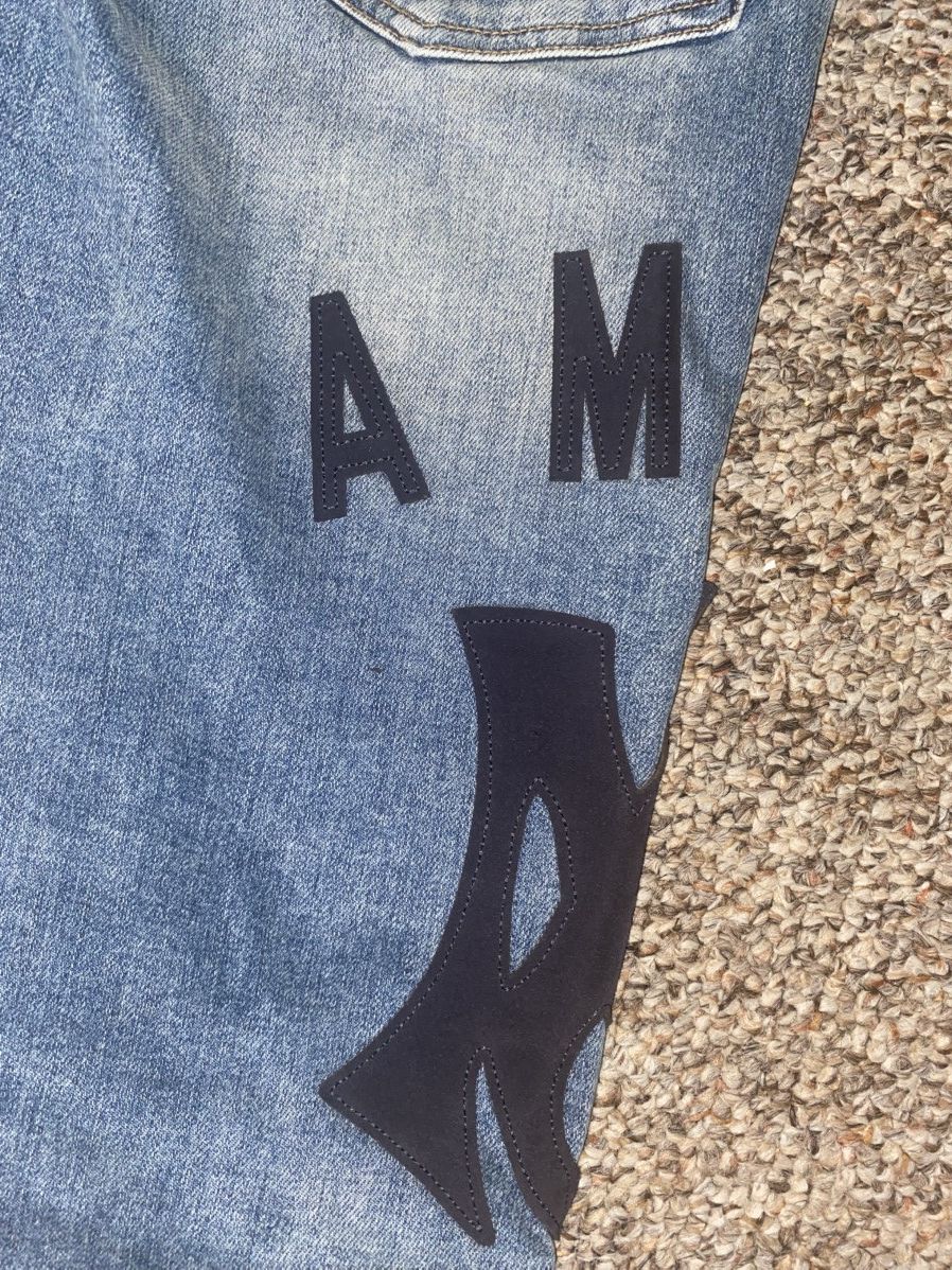 Amiri suede appliqué logo jeans