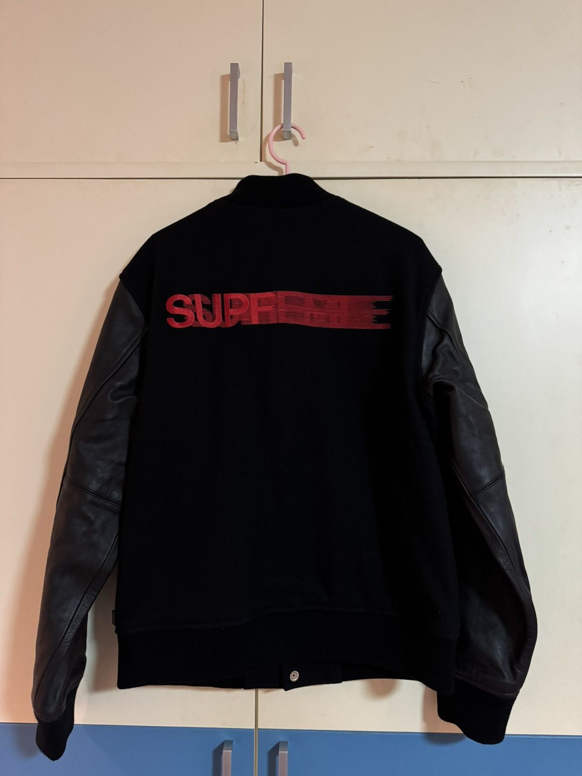 Supreme Supreme motion logo varsity jacket bomber black | Grailed
