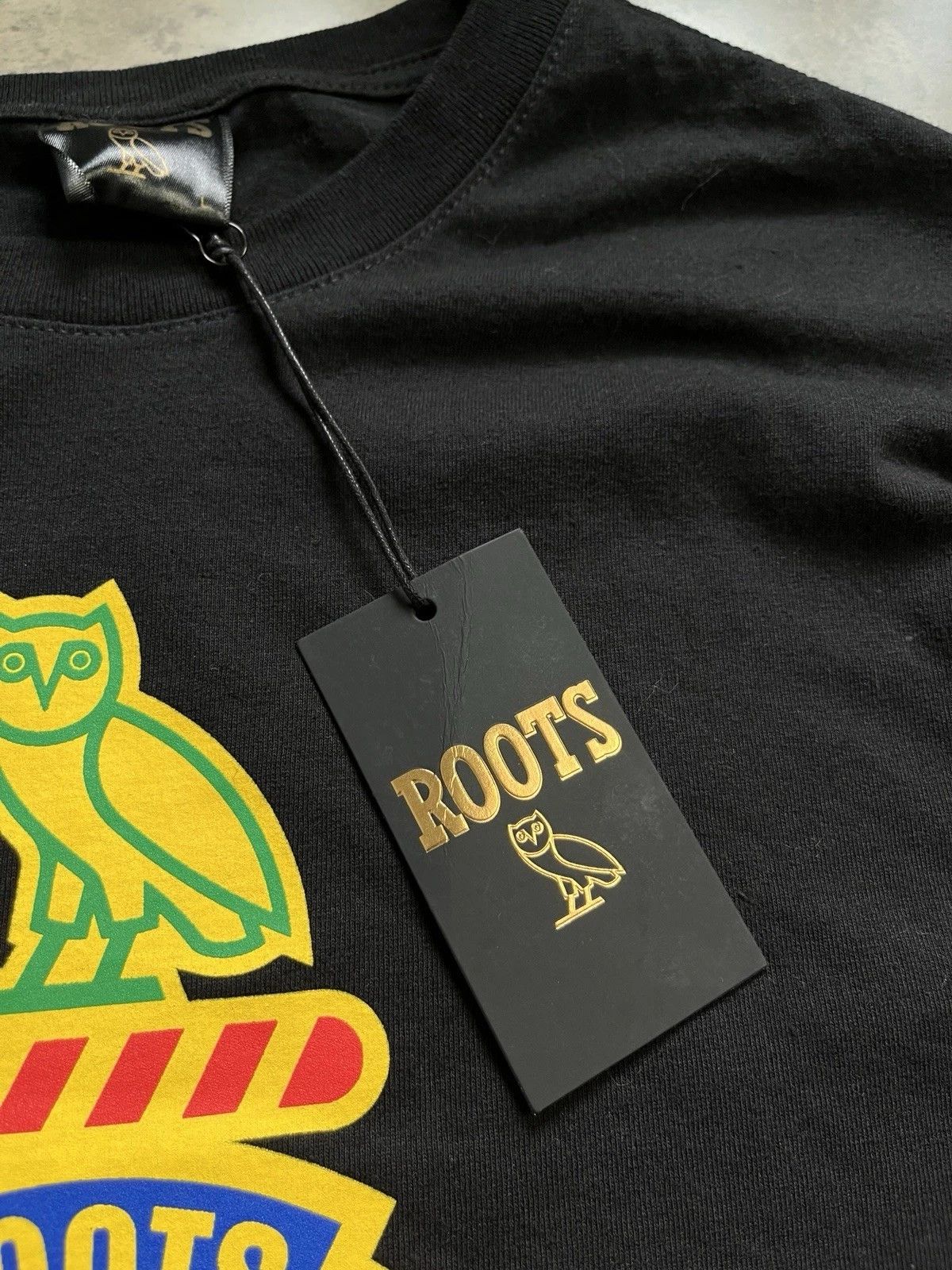 October's Very Own × Roots OVO October's Very Own x Roots Owl Tee Size US L / EU 52-54 / 3 - 7 Thumbnail