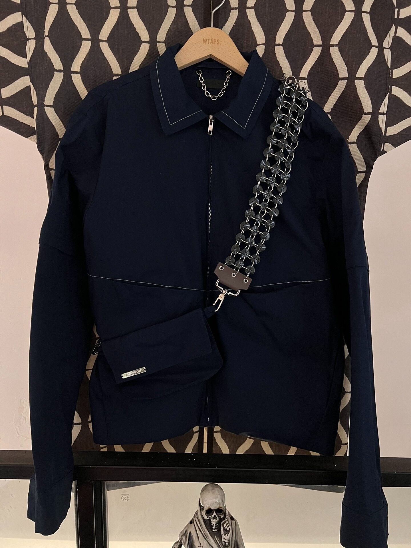 navy blue zip-up jacket with crossbody bag
