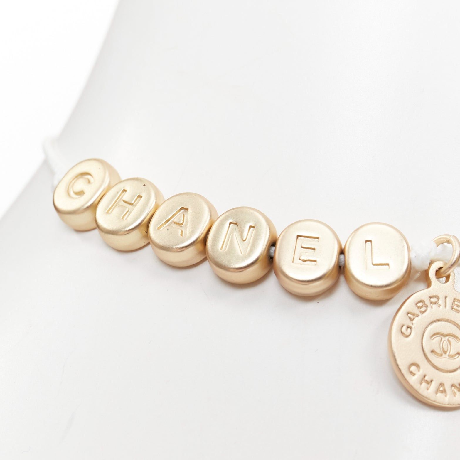 Chanel CHANEL white gold tone logo letter bead charm white thread lucky bracelet Size ONE SIZE - 1 Thumbnail