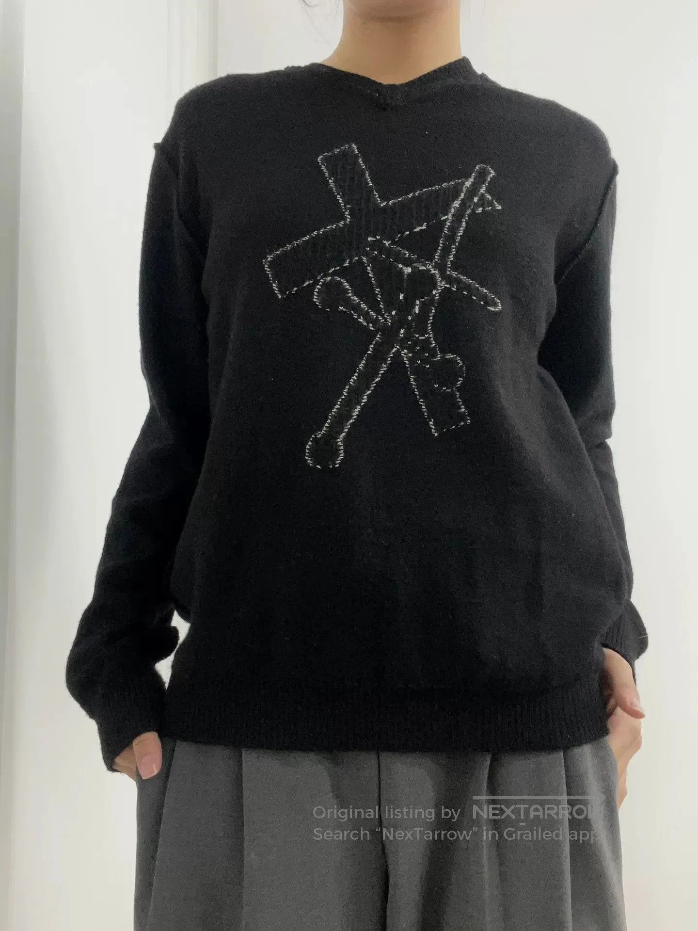 black knit sweater with unique design.