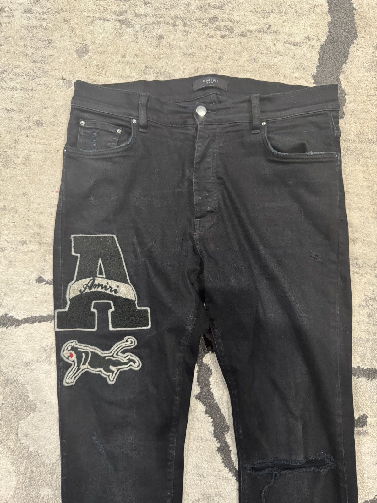 AMIRI VARSITY LOGO PATCH MEN'S DESTROYED BLACK SKINNY JEANS