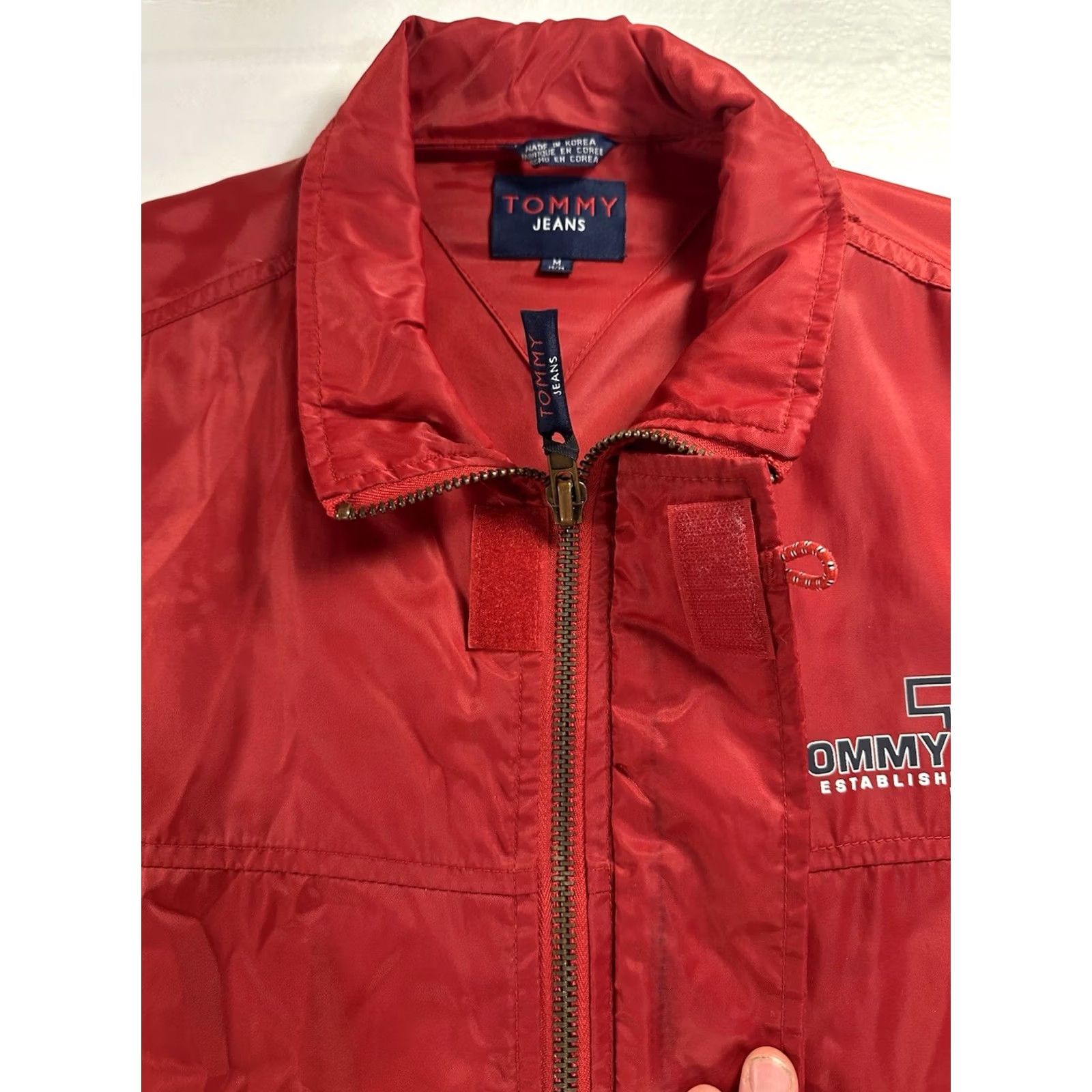 Tommy Hilfiger VTG Tommy Hilfiger Jeans Jacket Mens Medium Red Logo Windbreaker Hooded Nylon Front Zip Button Snap Sailor Windbreaker *Flaw" Size US 31 - 4 Thumbnail