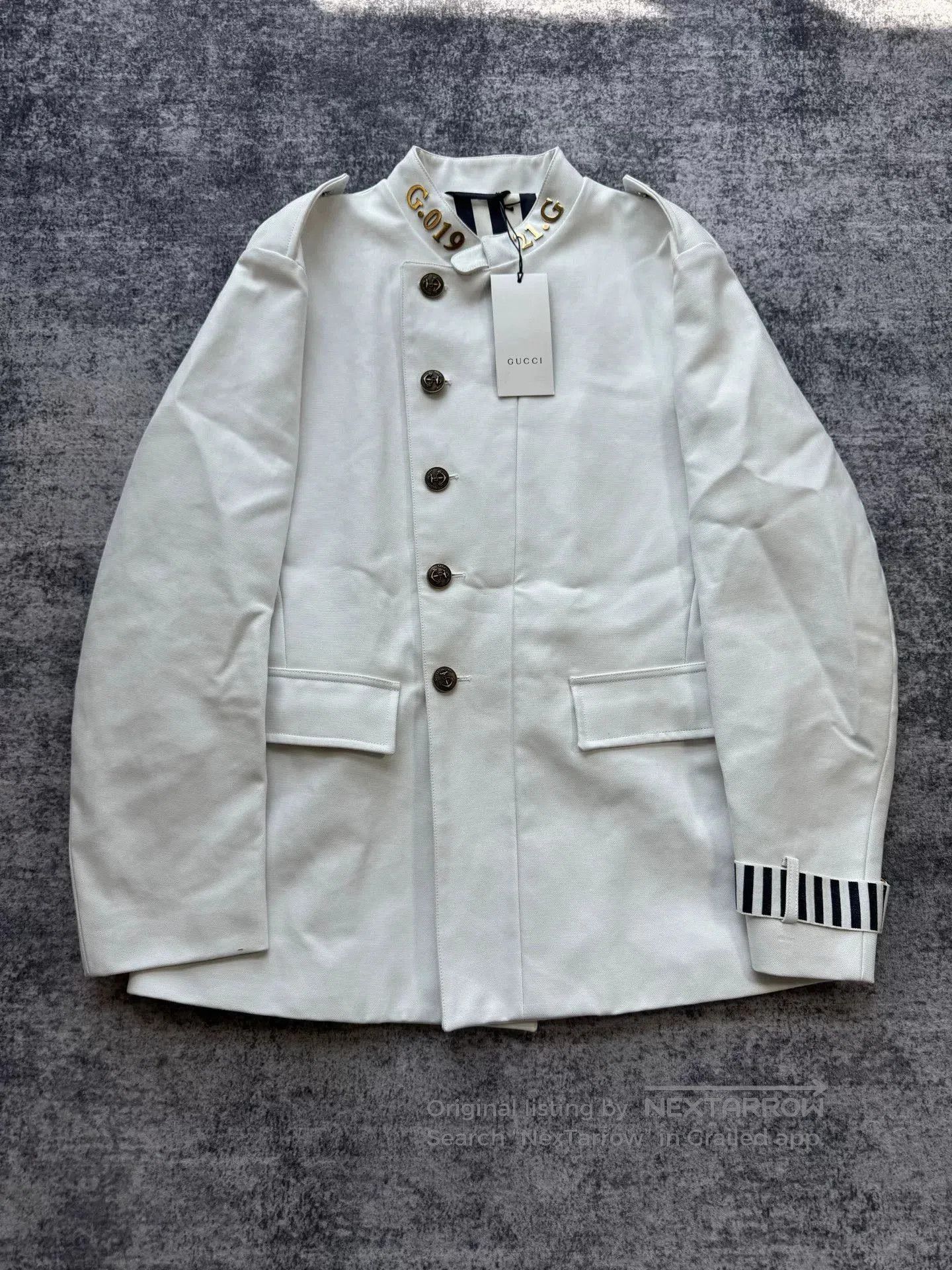 gucci white coat with metal logo collar.