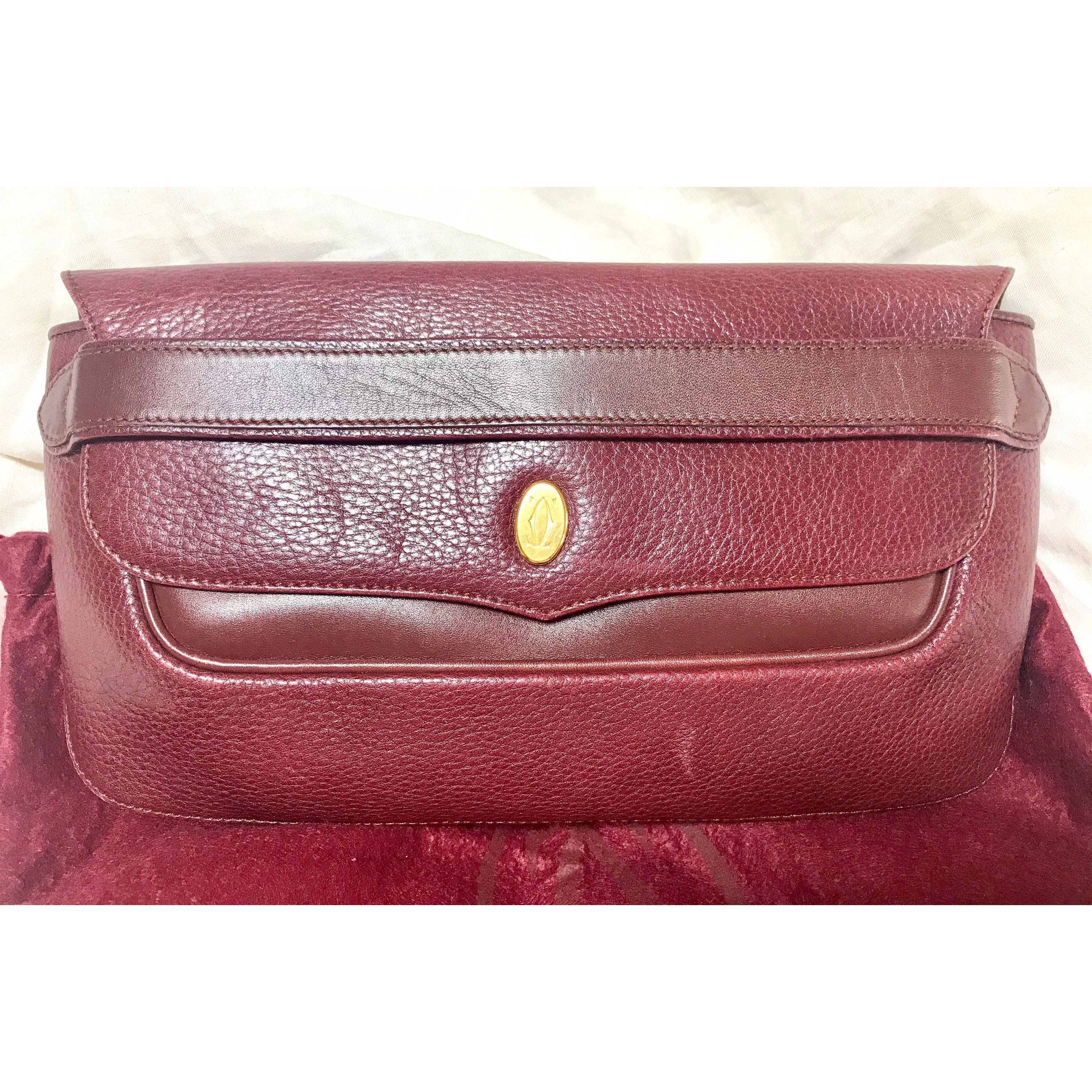 Vintage Cartier wine leather clutch bag with gold tone logo