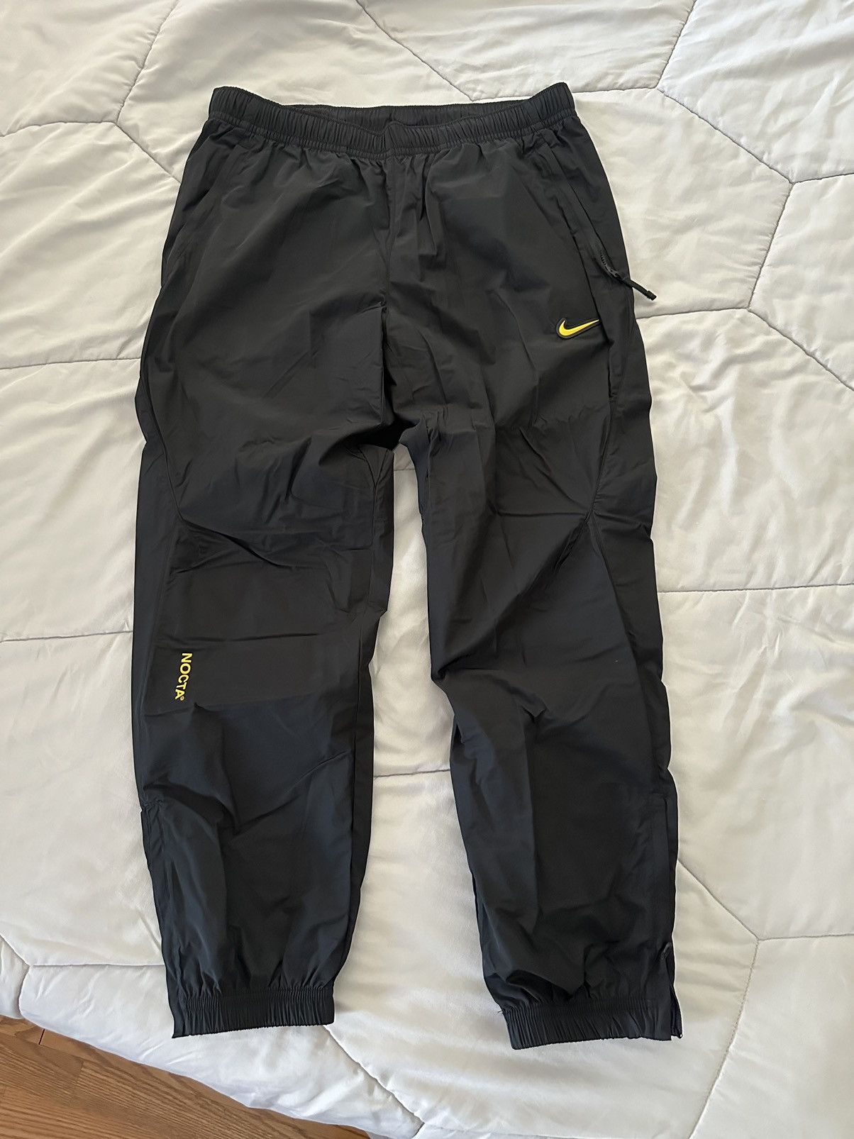 image of Nike Nocta Track Pants in Black, Men's (Size 34)