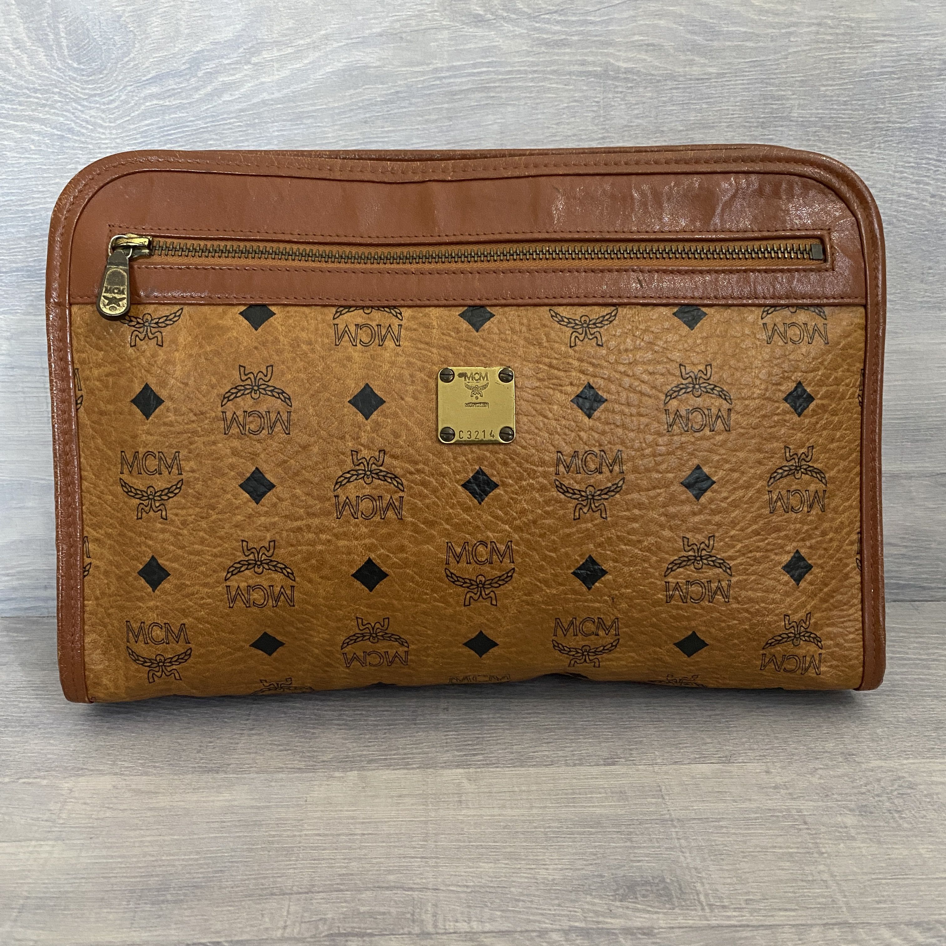 image of MCM All-Over Pattern Leather Clutch Bag in Brown, Men's