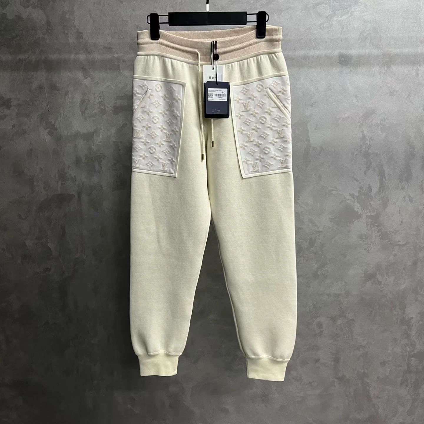 Louis Vuitton sweatpants with all-over print appliqué.