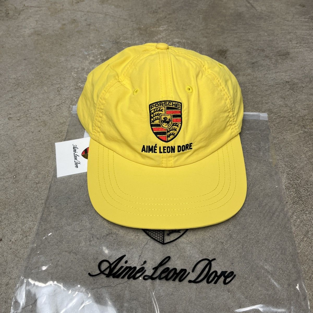 Aime Leon Dore Aime Leon Dore Porsche Logo Hat Aspen Gold Size ONE SIZE - 1 Thumbnail