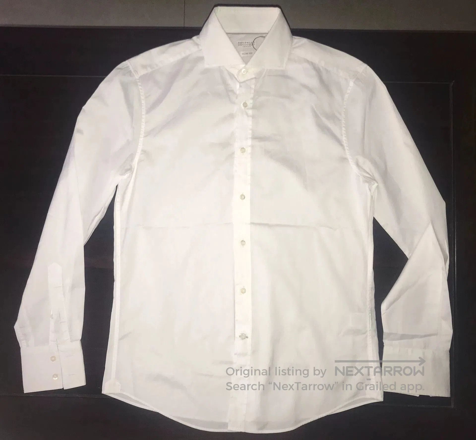 elegant white shirt with waterfall sleeves.