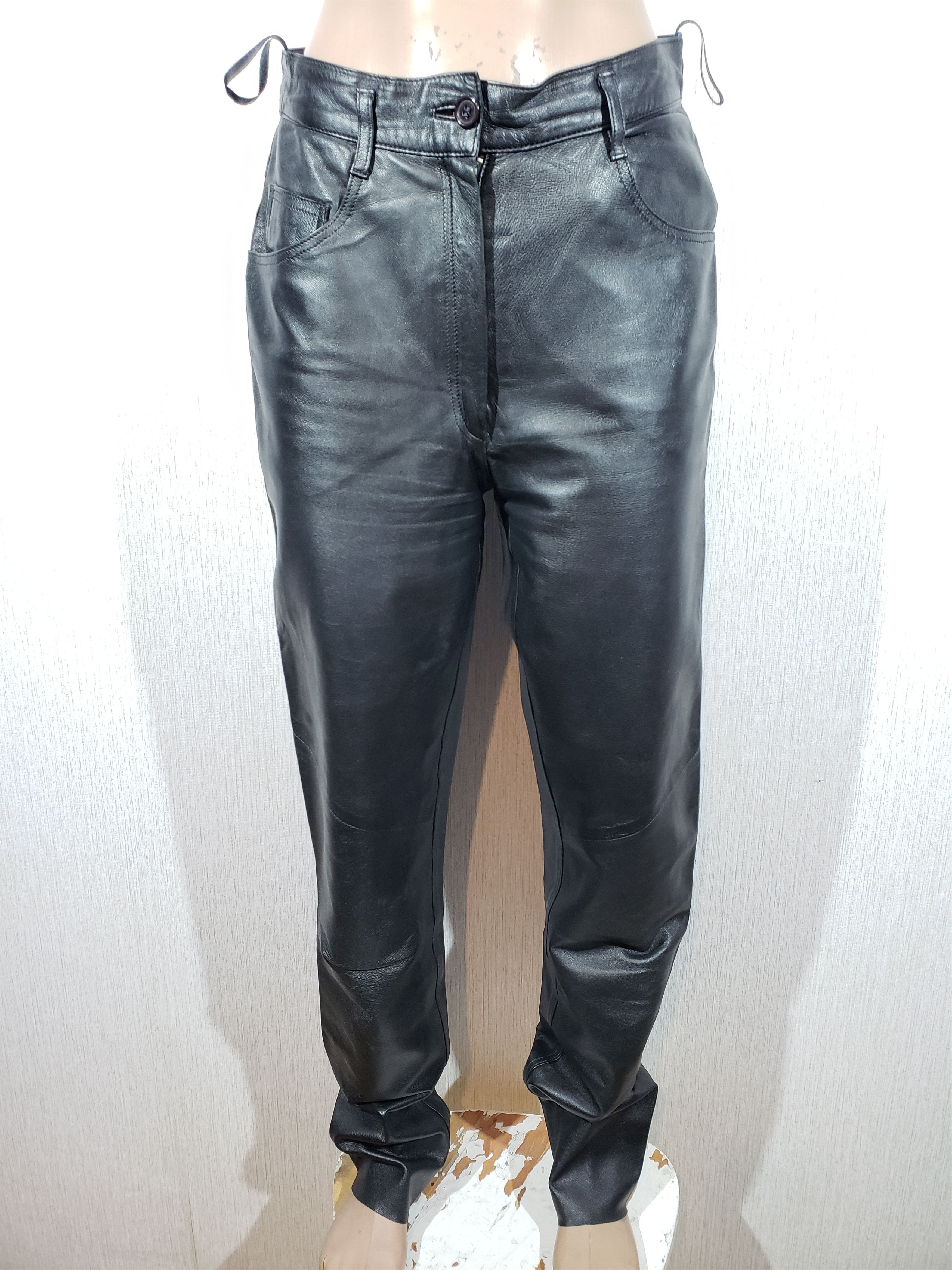 Stylish elegant women's black leather pants.