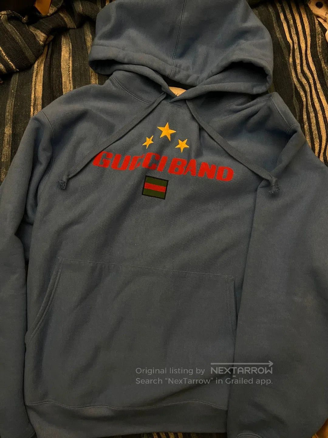 gucci blue hoodie with logo and stars.