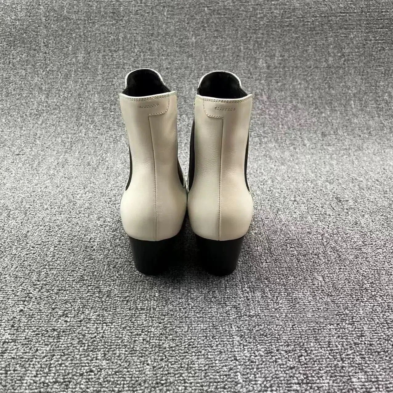 white leather pointed toe chelsea boots.
