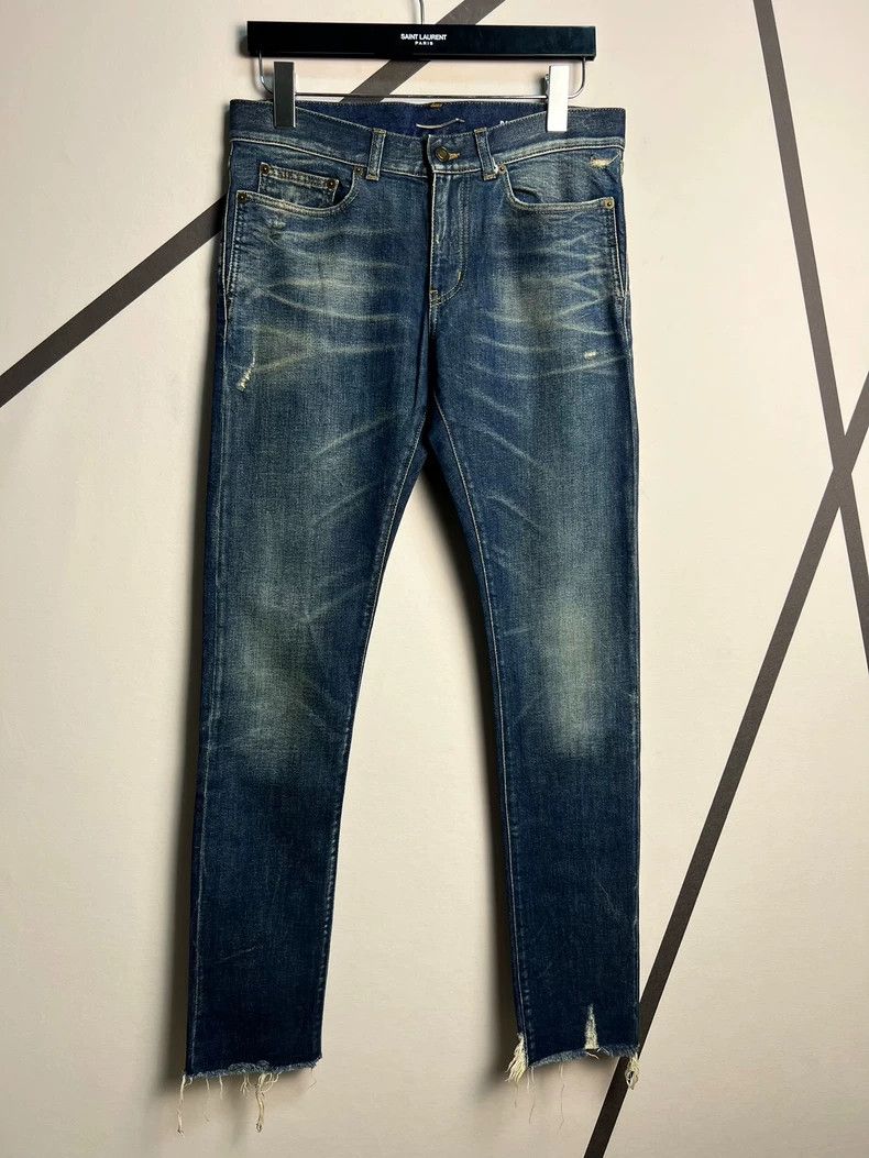 Saint Laurent Paris Blue jeans washed with fringed edges.