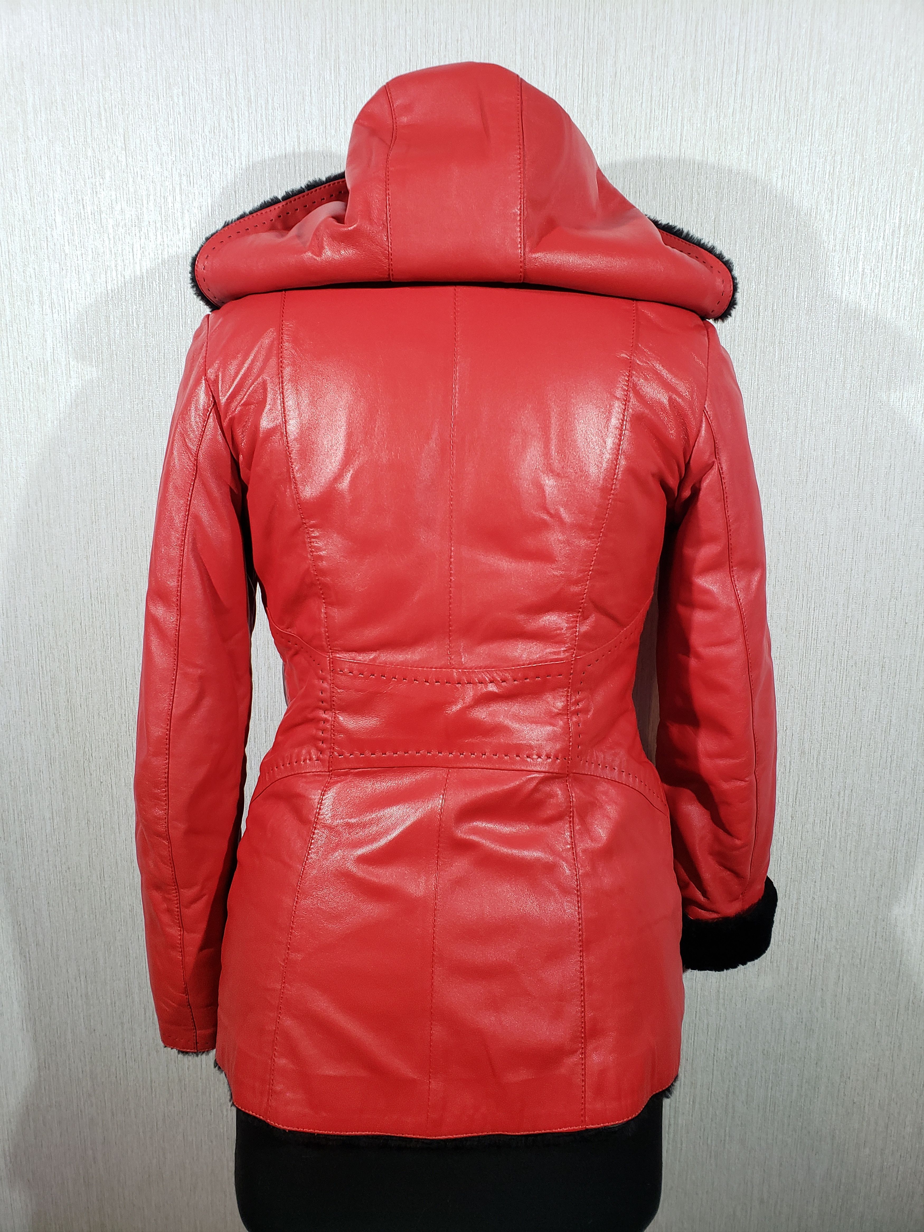 Stylish women's red sheepskin coat with a hood. Fur Faux Fur