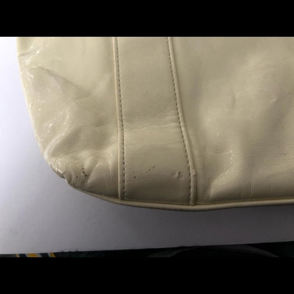 Cream hobo bag with silver plates on straps
