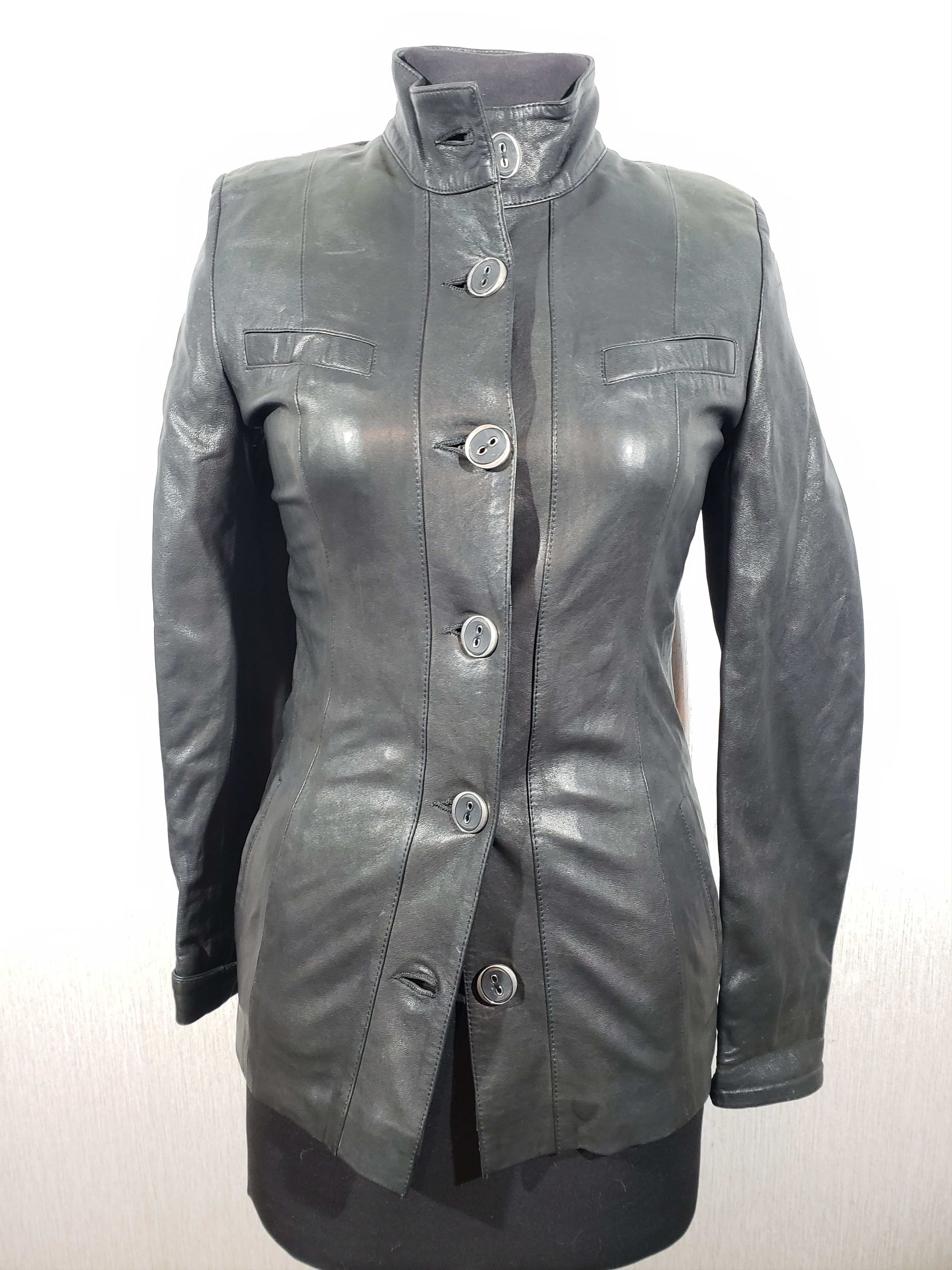 Stylish women's leather jacket with buttons.