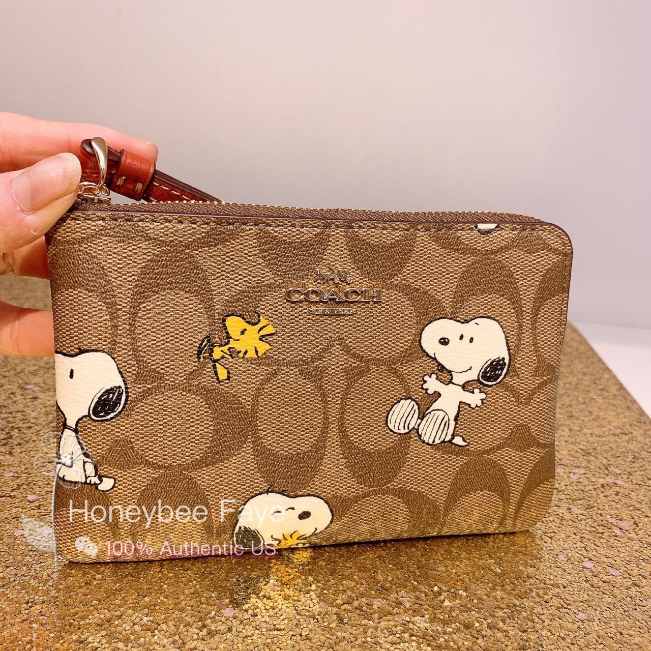 image of Coach X Peanuts Corner Zip Wristlet In Signature Canvas in Gold, Women's