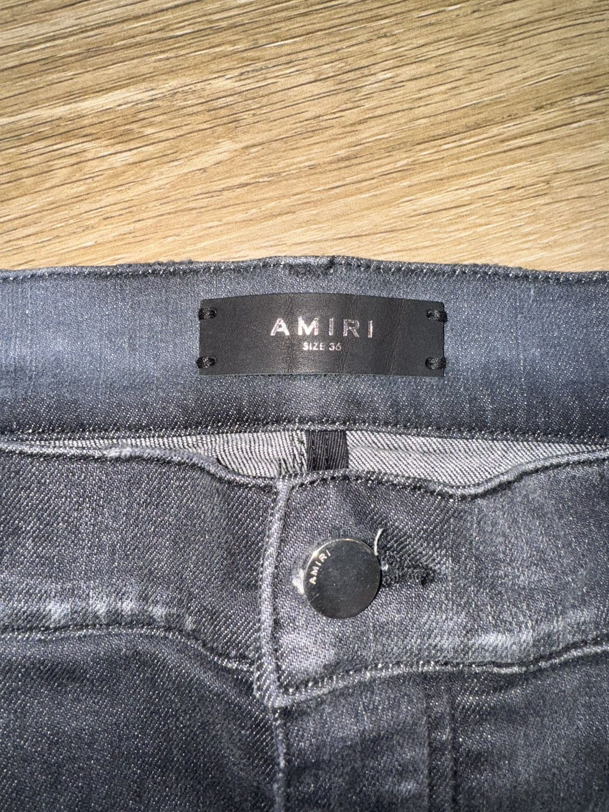 AMIRI logo-print ripped skinny jeans