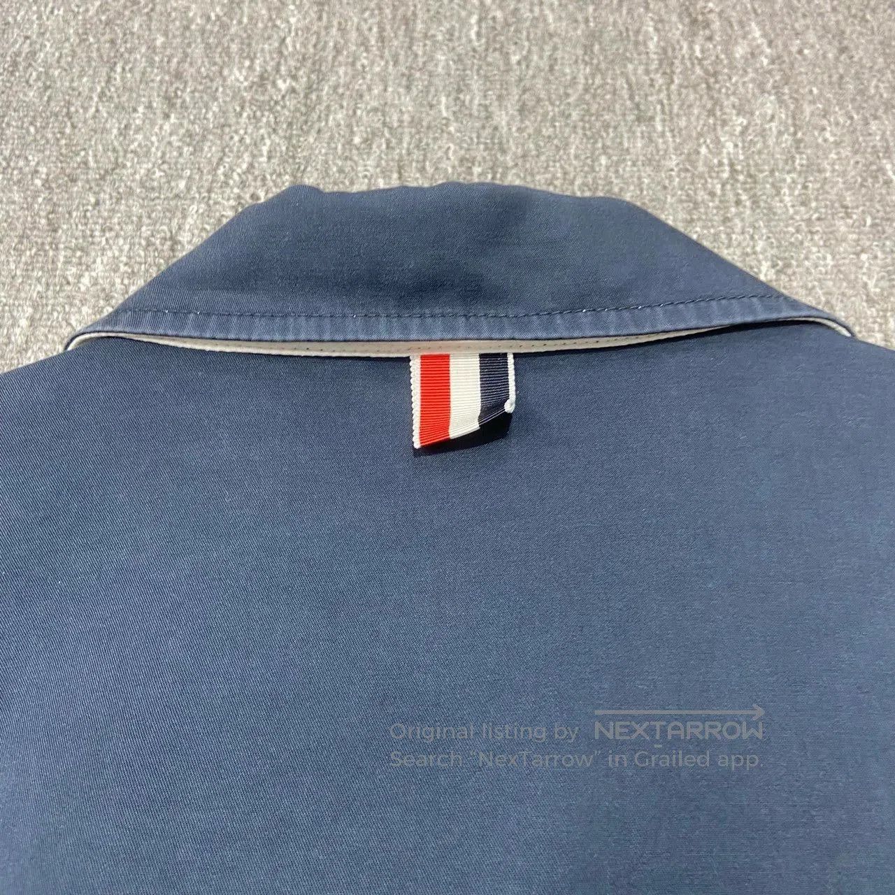 thom browne navy blue jacket with wear marks.