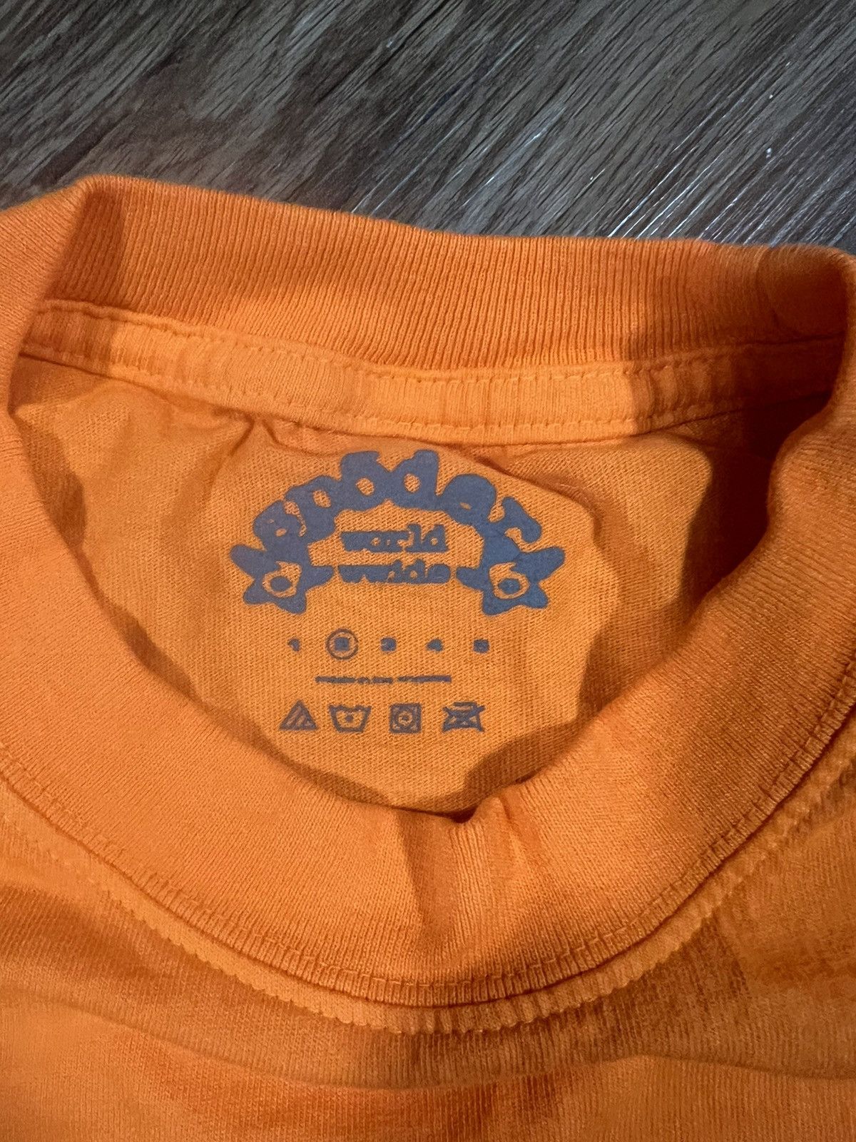Spider Worldwide Orange SP5 Baby Tee | WHAT'S ON THE STAR?