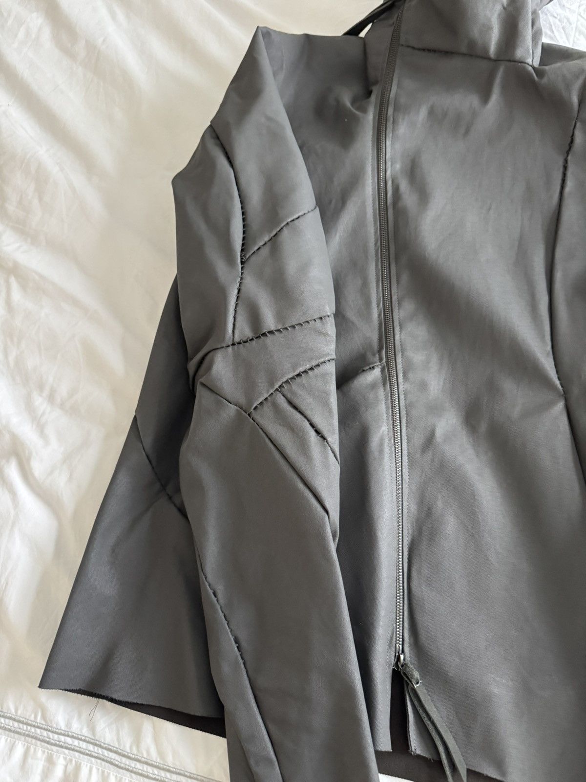 Unlined hand stitched hooded jacket.