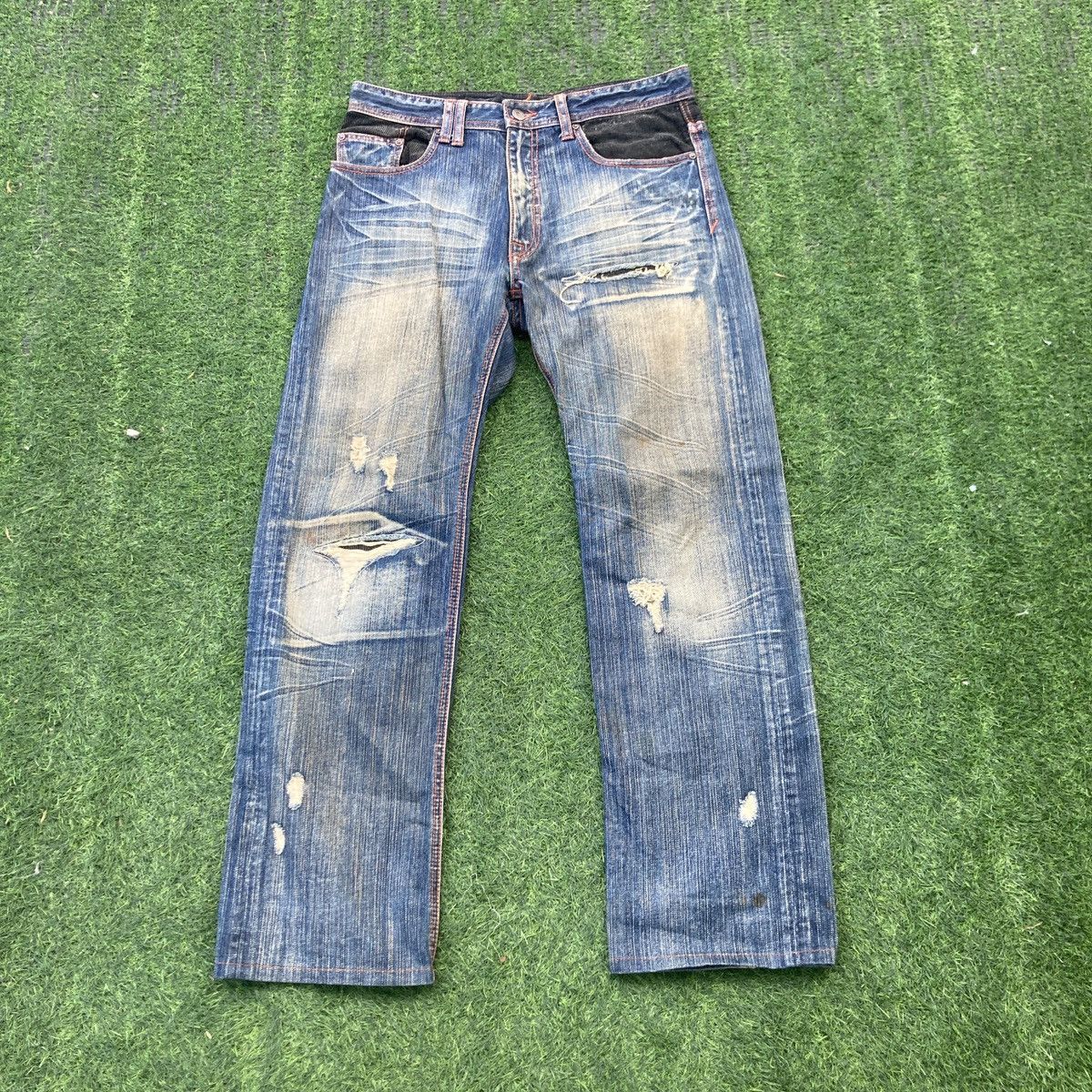 BOYCOTT FLARED RIPPED JEANS