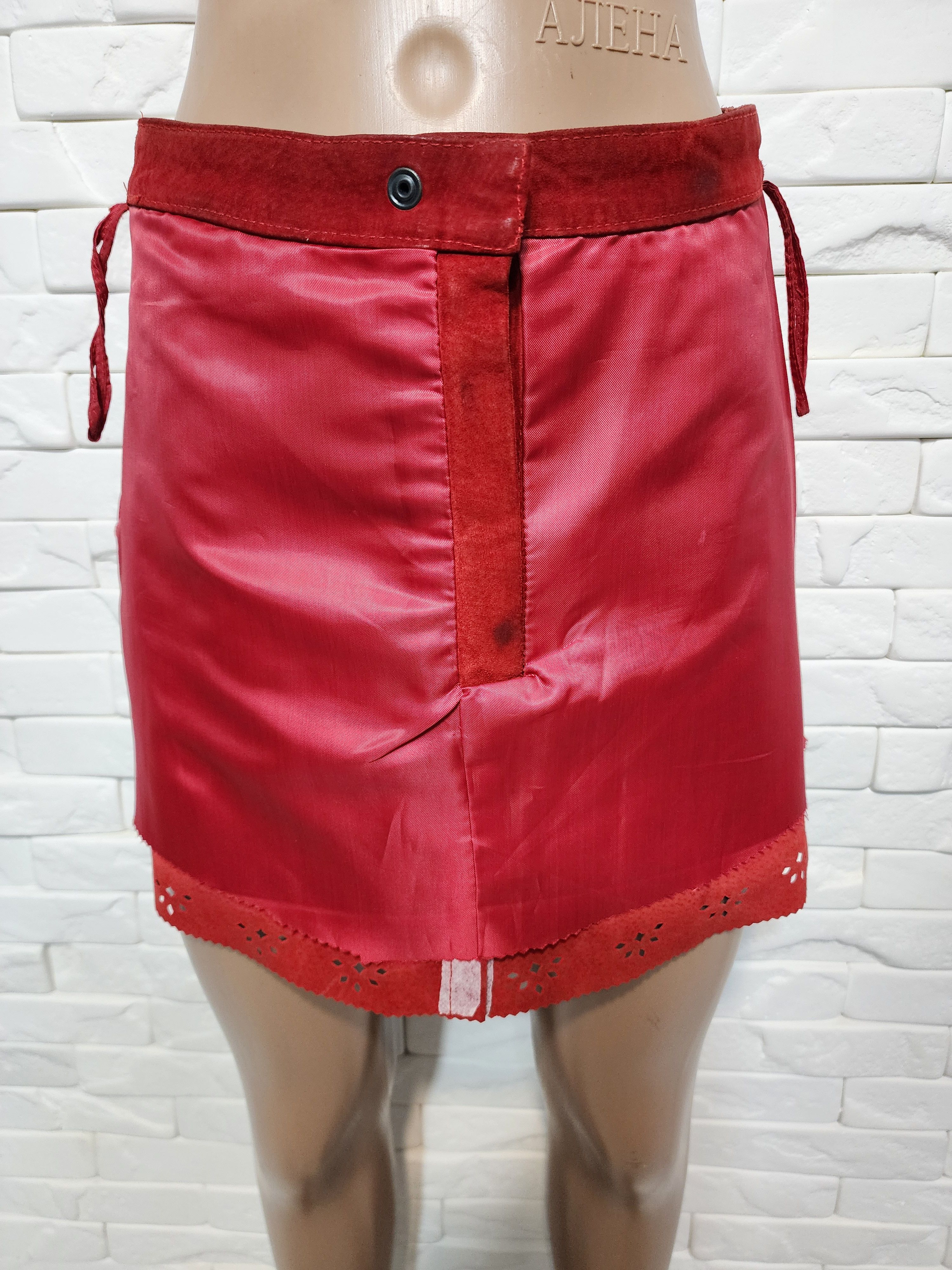 Red skirt made of genuine suede with perforation.